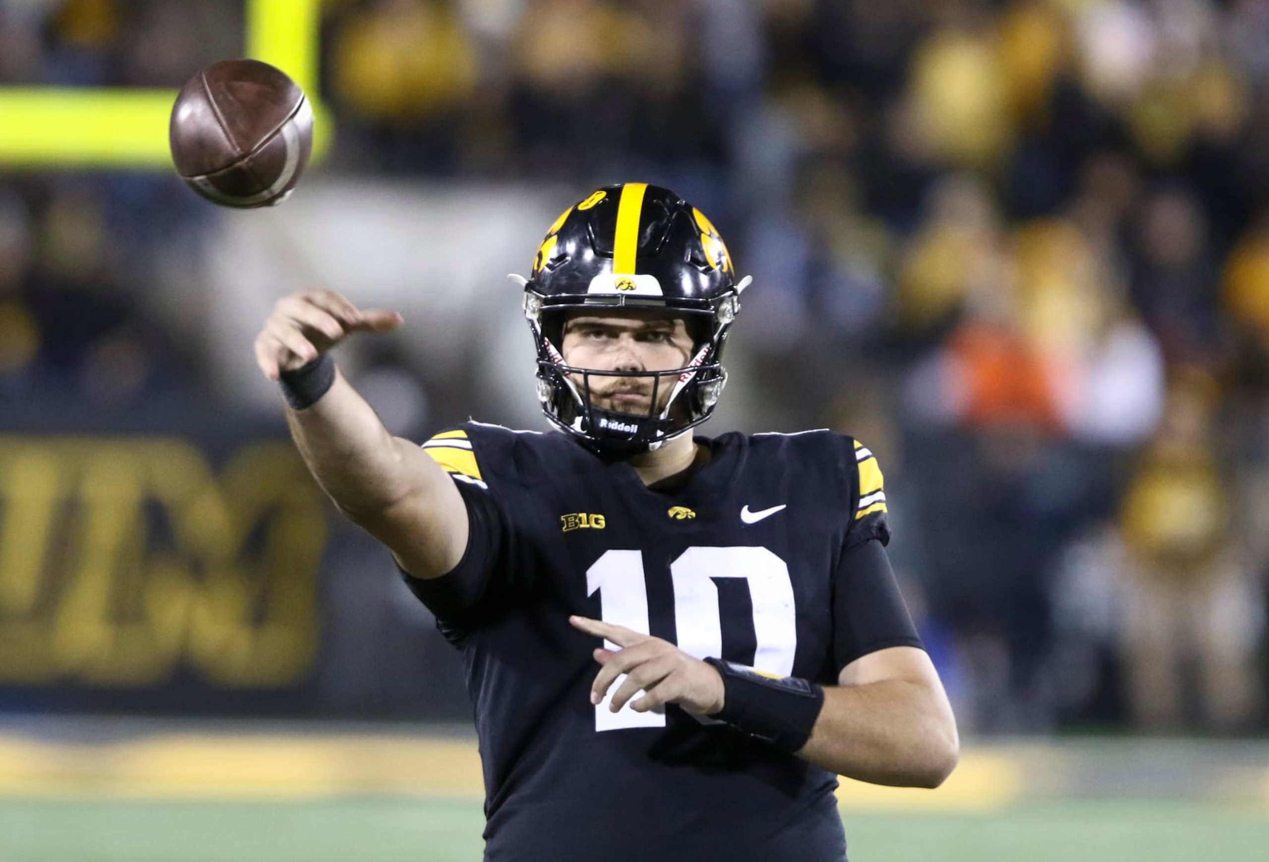 IOWA CITY, IOWA- NOVEMBER 18:  Quarterback Deacon Hill #10 of the Iowa Hawkeyes throws a pass to keep loose during the second half against the Illinois Fighting Illini at Kinnick Stadium on November 18, 2023 in Iowa City, Iowa.  (Photo by Matthew Holst/Getty Images)