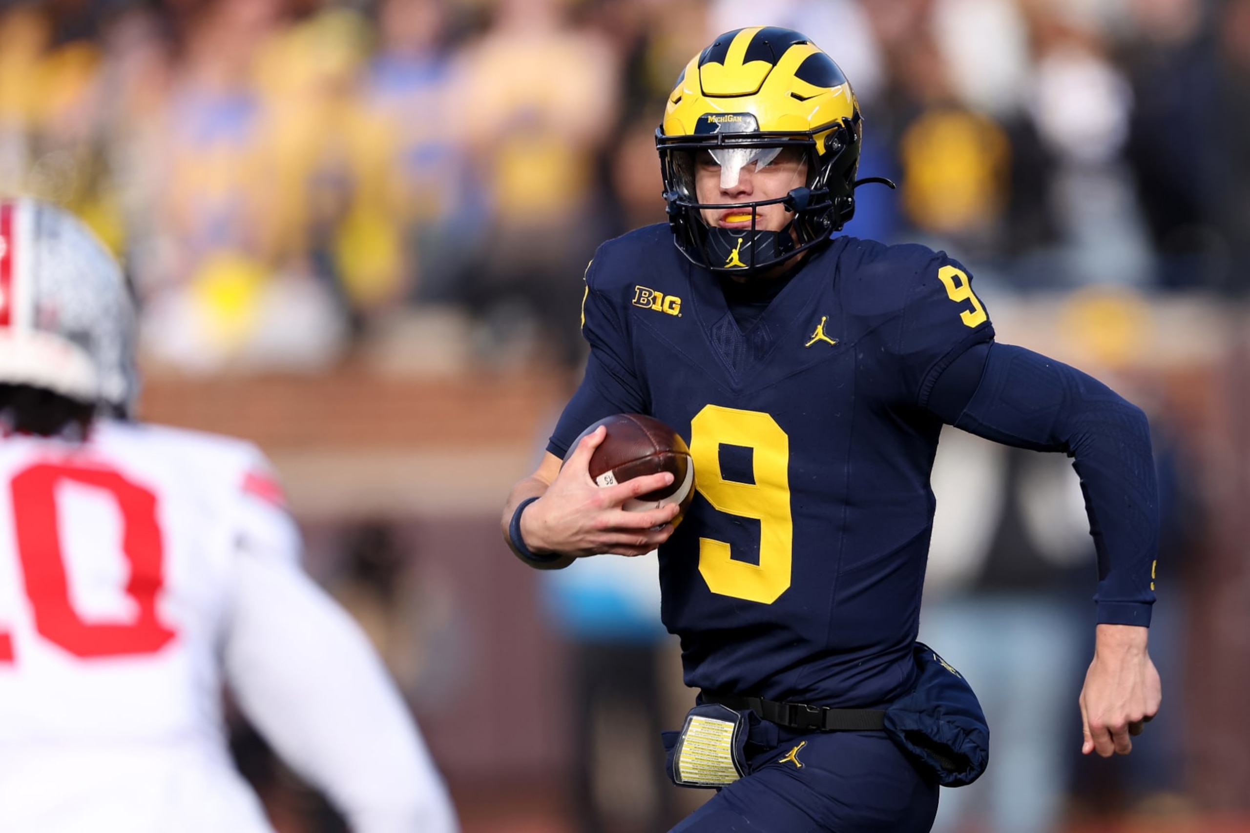 ANN ARBOR, MICHIGAN - NOVEMBER 25: J.J. McCarthy #9 of the Michigan Wolverines runs the ball against the Ohio State Buckeyes during the second quarter in the game at Michigan Stadium on November 25, 2023 in Ann Arbor, Michigan. (Photo by Gregory Shamus/Getty Images)