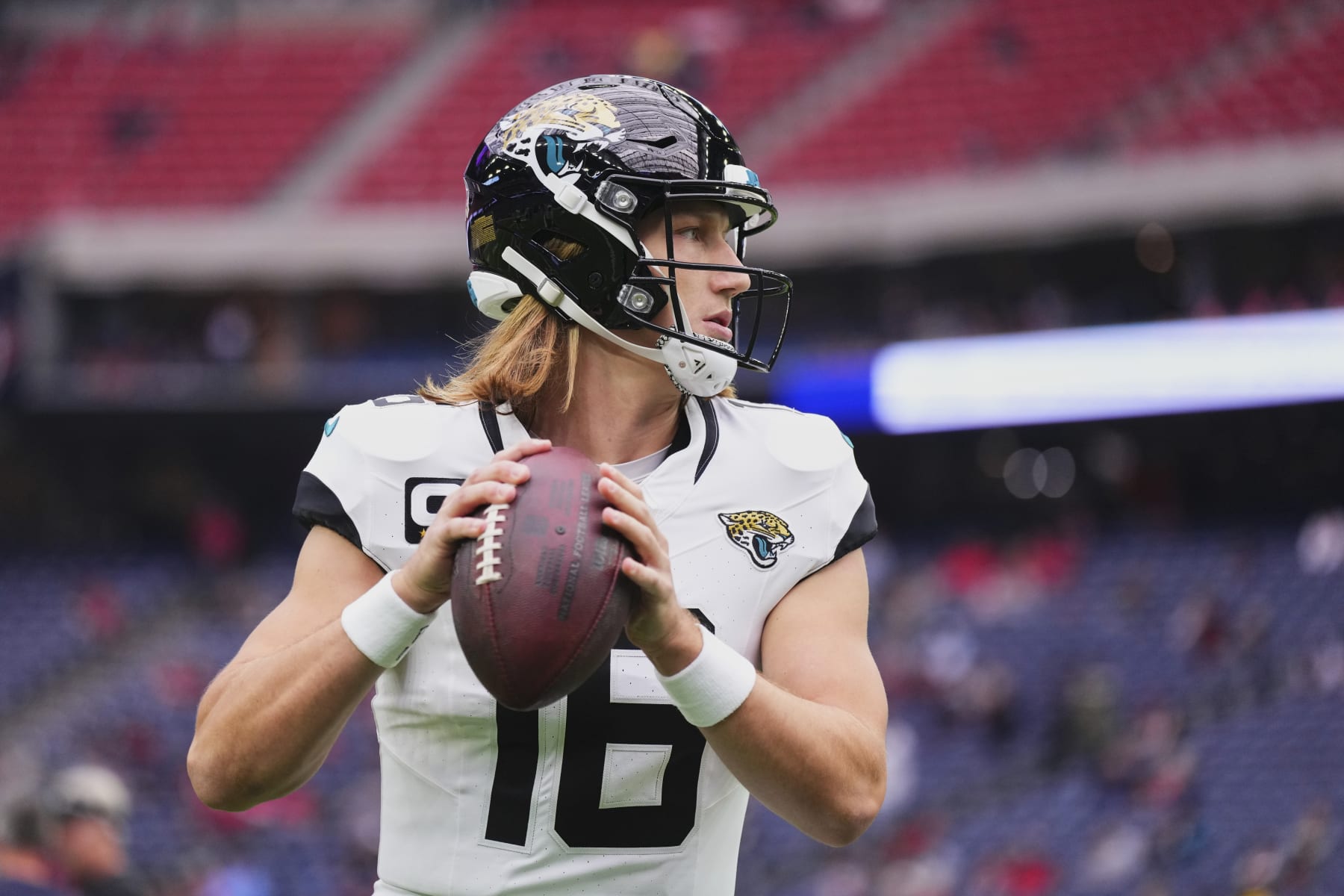 HOUSTON, TX - NOVEMBER 26: Trevor Lawrence #16 of the Jacksonville Jaguars warms up before kickoff against the Houston Texans at NRG Stadium on November 26, 2023 in Houston, Texas. (Photo by Cooper Neill/Getty Images)