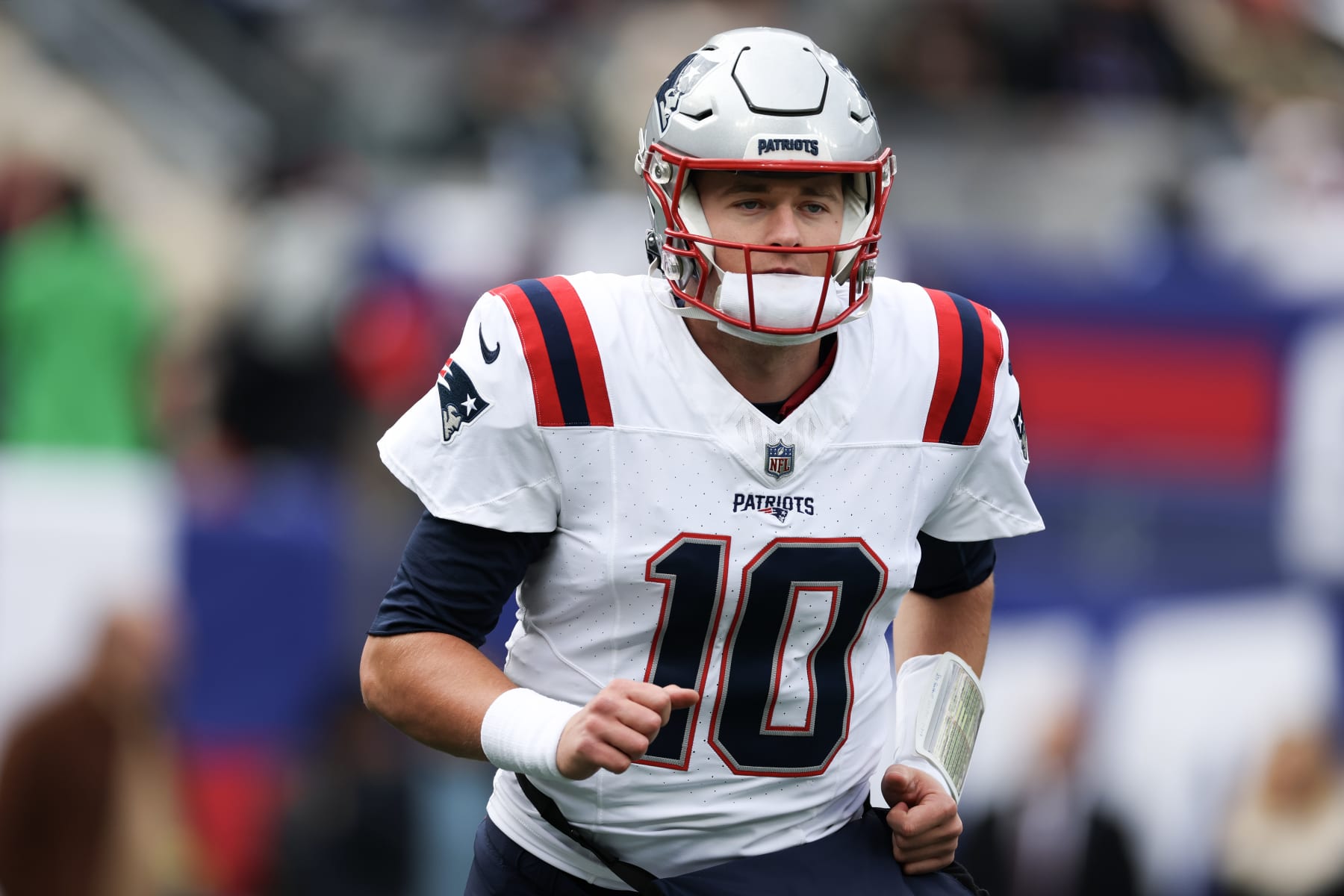 EAST RUTHERFORD, NEW JERSEY - NOVEMBER 26: Mac Jones #10 of the New England Patriots looks on prior to a game against the New York Giants at MetLife Stadium on November 26, 2023 in East Rutherford, New Jersey. (Photo by Al Bello/Getty Images)