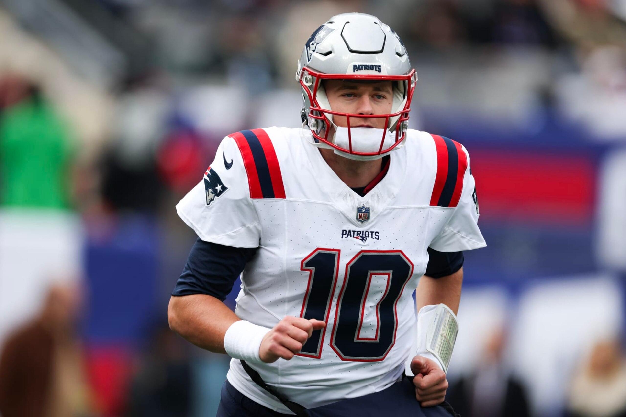 EAST RUTHERFORD, NEW JERSEY - NOVEMBER 26: Mac Jones #10 of the New England Patriots looks on prior to a game against the New York Giants at MetLife Stadium on November 26, 2023 in East Rutherford, New Jersey. (Photo by Al Bello/Getty Images)
