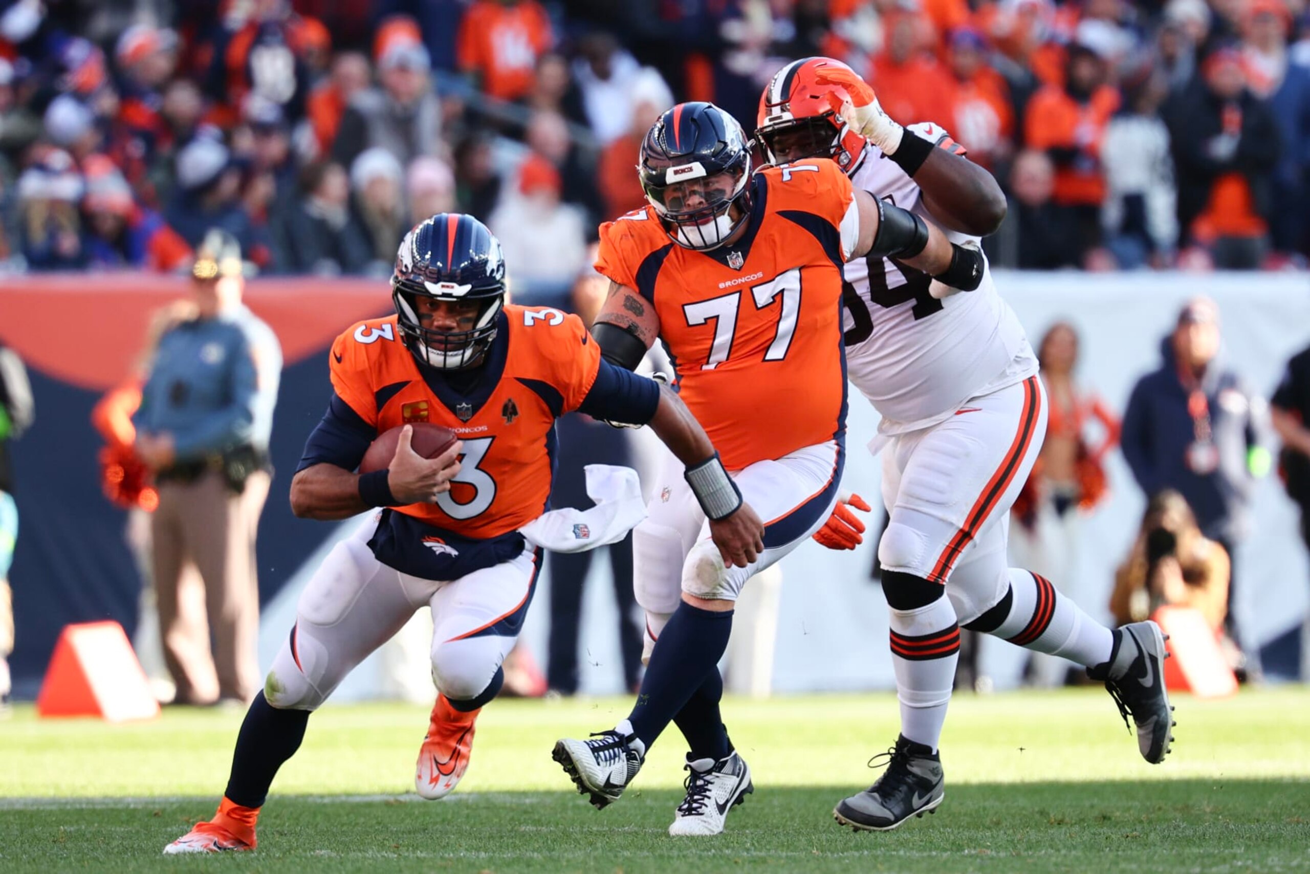 DENVER, COLORADO - NOVEMBER 26: Russell Wilson #3 of the Denver Broncos runs with the ball in the first quarter of the game against the Cleveland Browns at Empower Field At Mile High on November 26, 2023 in Denver, Colorado. (Photo by Jamie Schwaberow/Getty Images) DENVER, COLORADO - NOVEMBER 26: Russell Wilson #3 of the Denver Broncos runs with the ball in the first quarter of the game against the Cleveland Browns at Empower Field At Mile High on November 26, 2023 in Denver, Colorado. (Photo by Jamie Schwaberow/Getty Images)