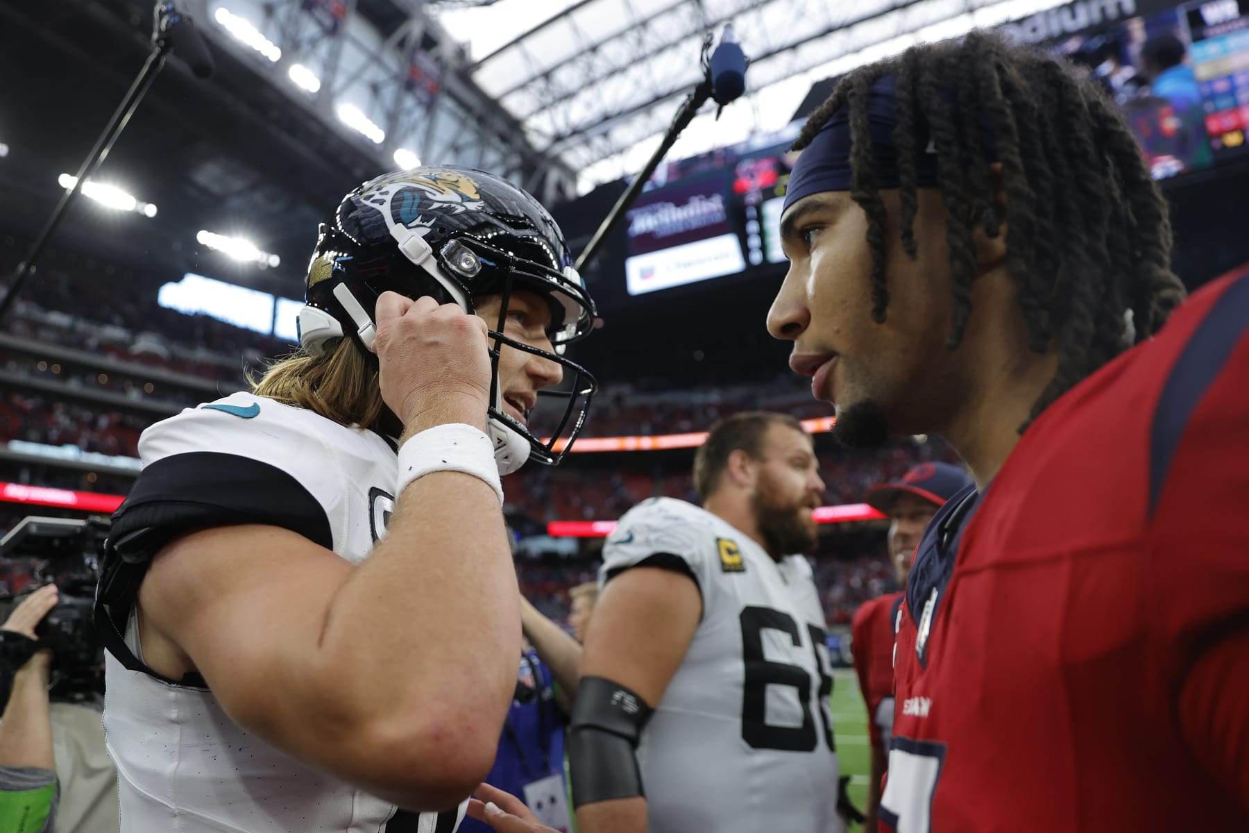 HOUSTON, TEXAS - NOVEMBER 26: Trevor Lawrence #16 of the Jacksonville Jaguars and C.J. Stroud #7 of the Houston Texans meet after their game at NRG Stadium on November 26, 2023 in Houston, Texas. (Photo by Carmen Mandato/Getty Images)