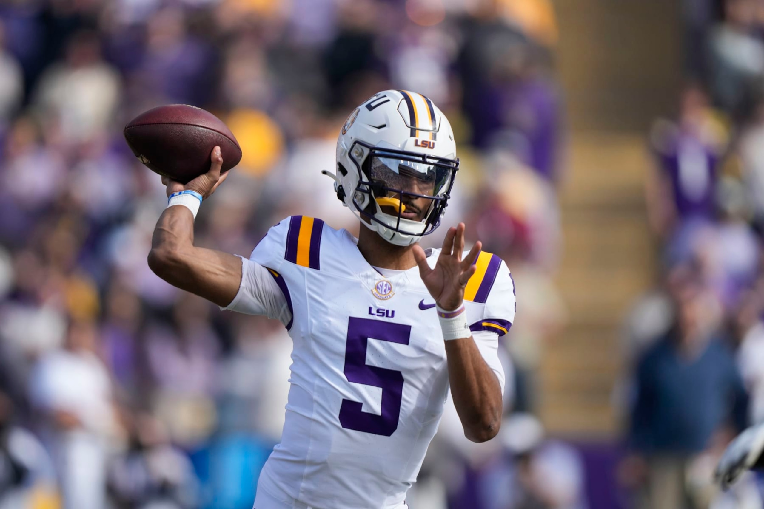 LSU quarterback Jayden Daniels (5) passes in the first half of an NCAA college football game against Texas A&M in Baton Rouge, La., Saturday, Nov. 25, 2023. (AP Photo/Gerald Herbert) LSU quarterback Jayden Daniels (5) passes in the first half of an NCAA college football game against Texas A&M in Baton Rouge, La., Saturday, Nov. 25, 2023. (AP Photo/Gerald Herbert)