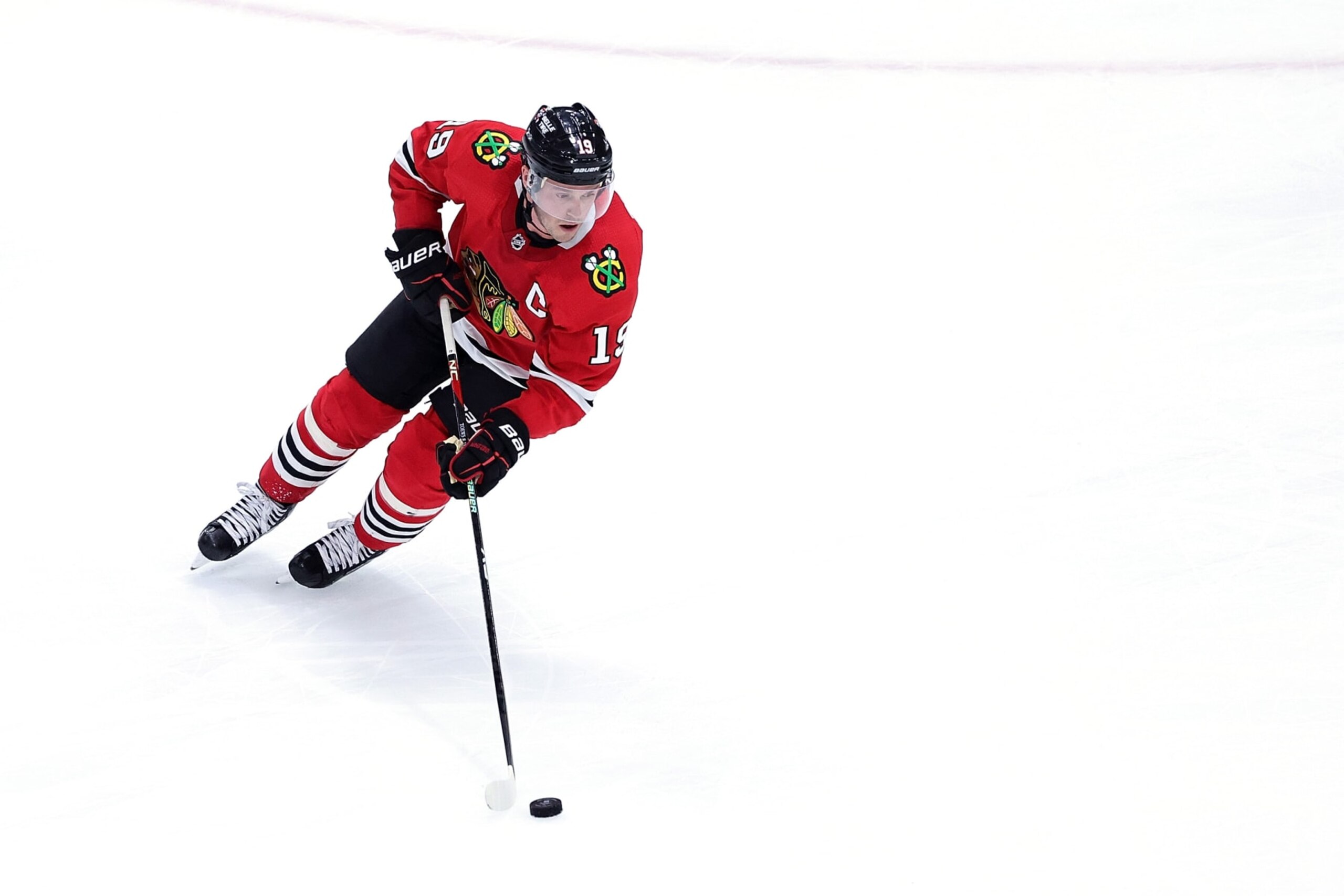 CHICAGO, ILLINOIS - APRIL 13: Jonathan Toews #19 of the Chicago Blackhawks controls the puck during a game against the Philadelphia Flyers at the United Center on April 13, 2023 in Chicago, Illinois.  The Flyers defeated the Blackhawks 5-4 in overtime. (Photo by Stacy Revere/Getty Images)
