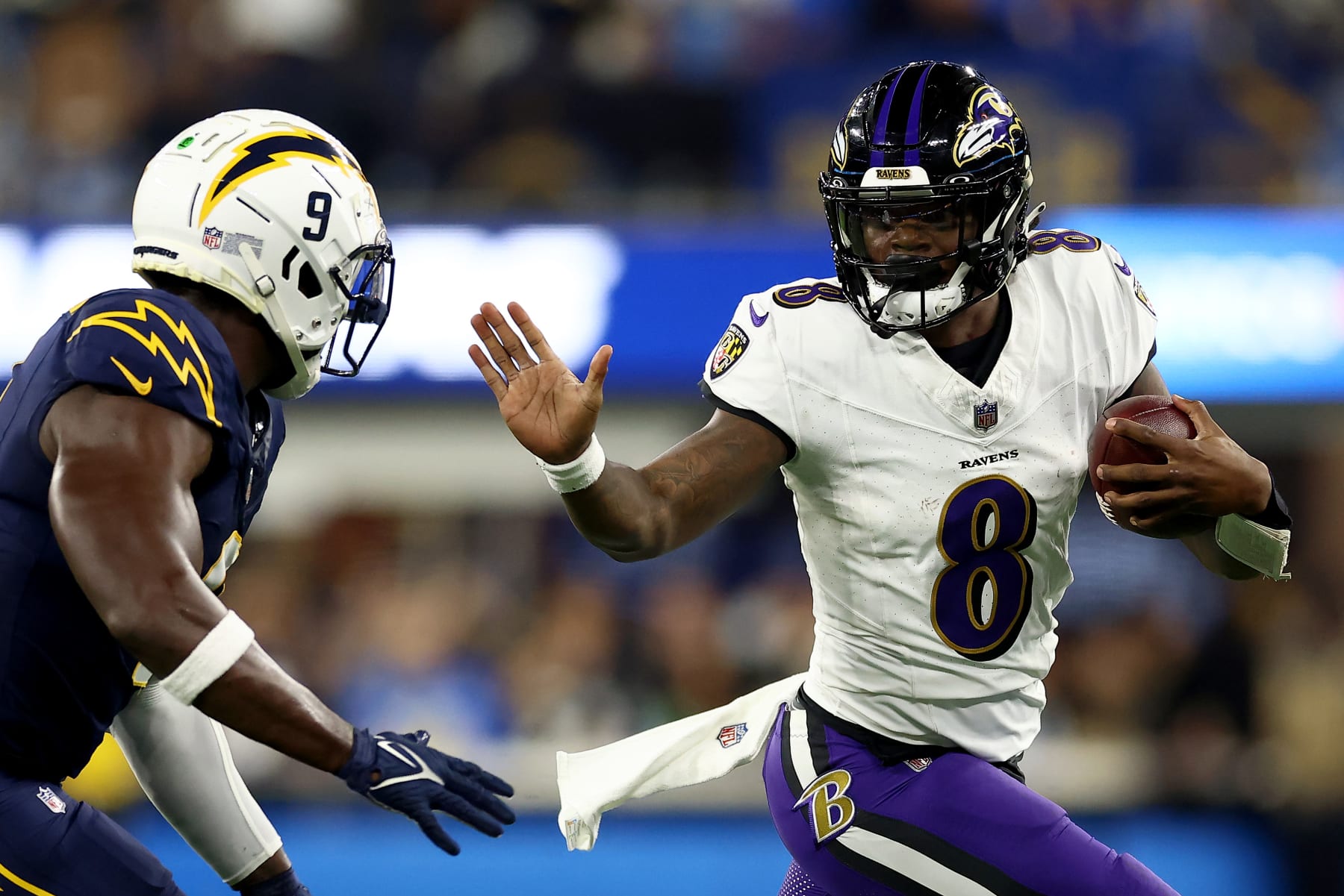 INGLEWOOD, CALIFORNIA - NOVEMBER 26: Lamar Jackson #8 of the Baltimore Ravens runs the ball against Kenneth Murray Jr. #9 of the Los Angeles Chargers during the second quarter in the game at SoFi Stadium on November 26, 2023 in Inglewood, California. (Photo by Katelyn Mulcahy/Getty Images)