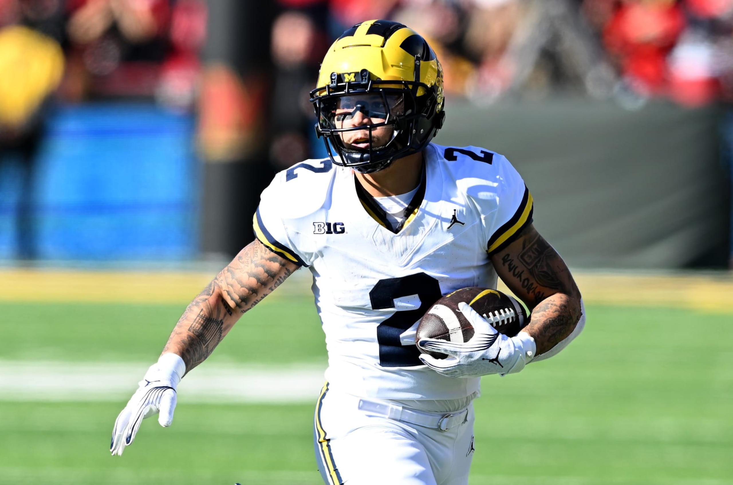 COLLEGE PARK, MARYLAND - NOVEMBER 18: Blake Corum #2 of the Michigan Wolverines rushes the ball against the Maryland Terrapins at SECU Stadium on November 18, 2023 in College Park, Maryland. (Photo by G Fiume/Getty Images)