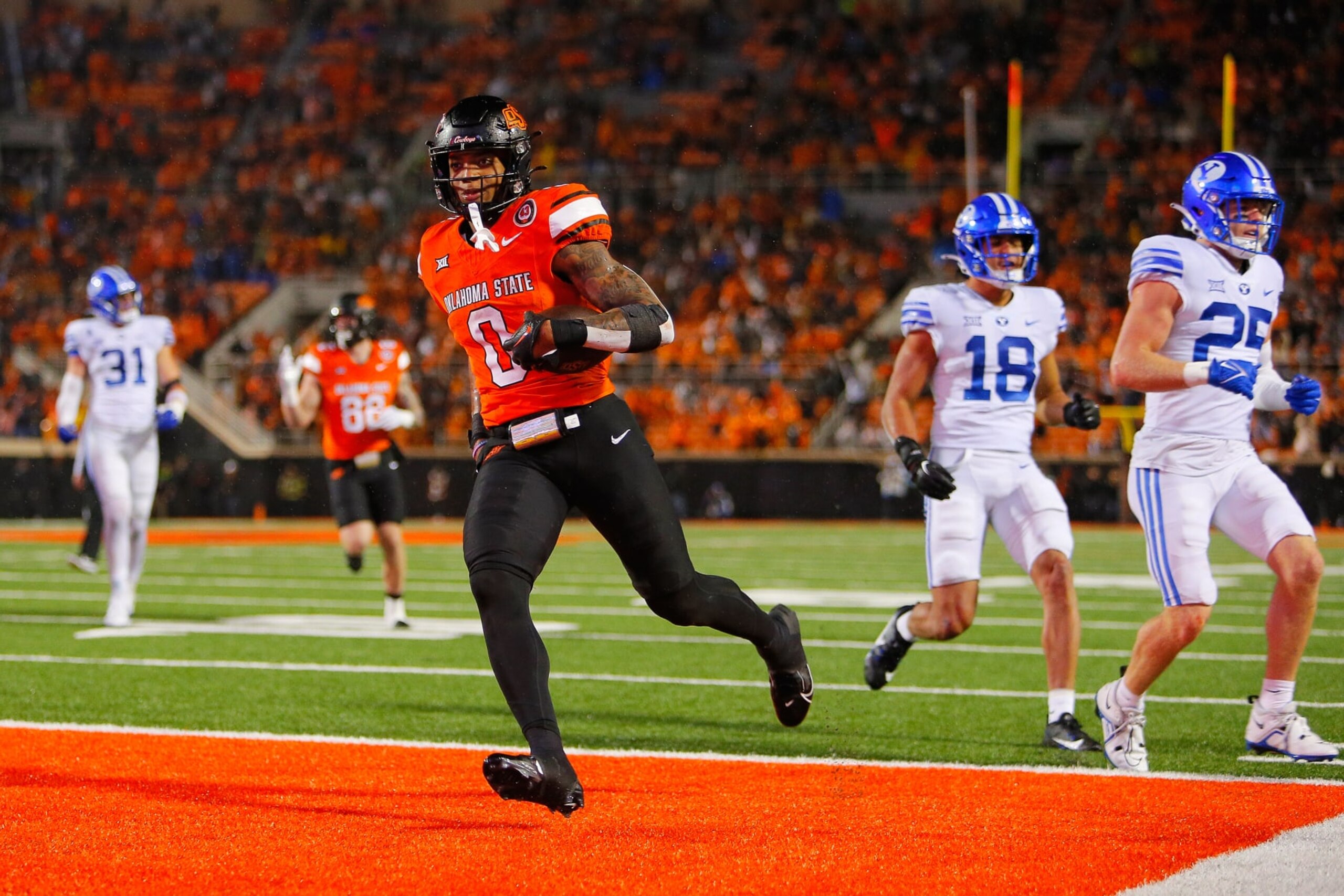 STILLWATER, OK - NOVEMBER 25:  Running back Ollie Gordon II #0 of the Oklahoma State Cowboys sticks out his tongue after scoring a go-ahead touchdown against the BYU Cougars late in the fourth quarter at Boone Pickens Stadium on November 25, 2023 in Stillwater, Oklahoma.  Oklahoma State won 40-34 in double overtime.  (Photo by Brian Bahr/Getty Images)