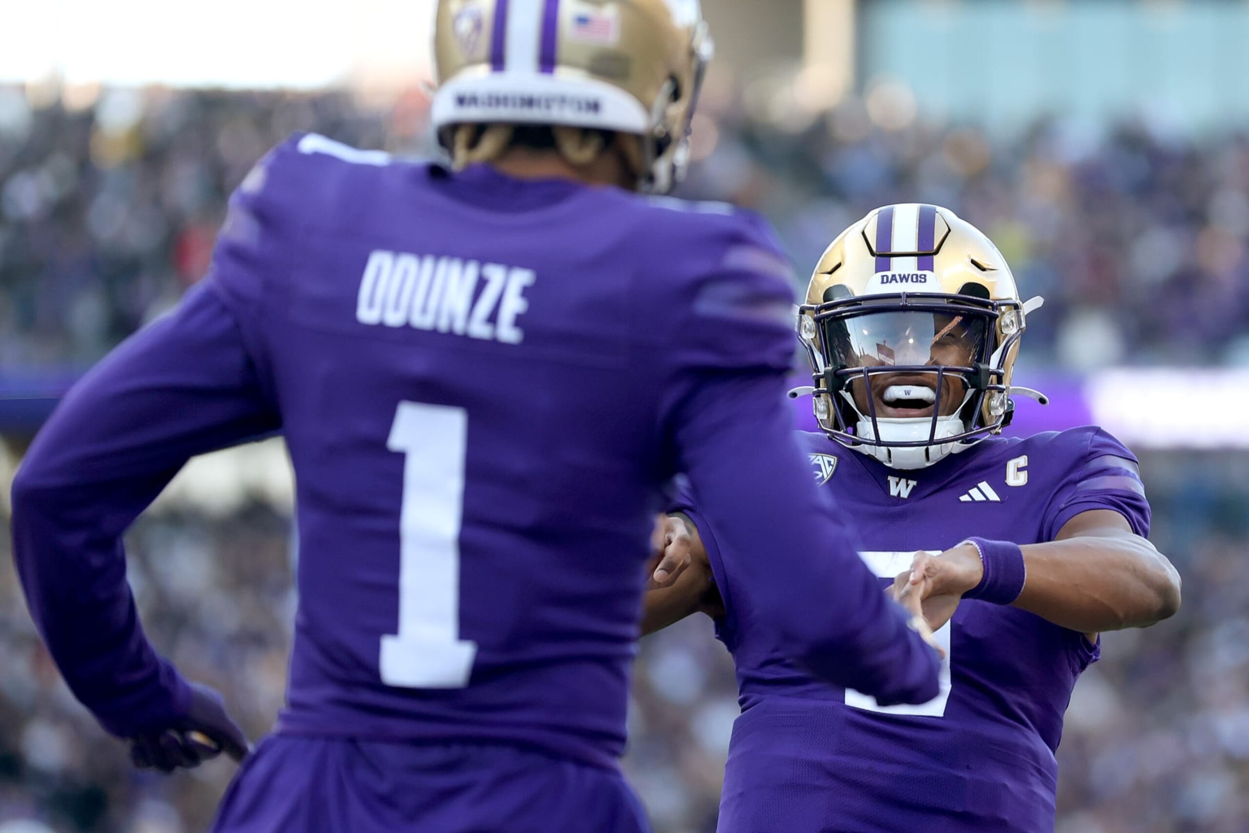 SEATTLE, WASHINGTON - NOVEMBER 25: Rome Odunze #1 of the Washington Huskies celebrates his touchdown with Michael Penix Jr. #9 of the Washington Huskies against the Washington State Cougars at Husky Stadium on November 25, 2023 in Seattle, Washington. (Photo by Steph Chambers/Getty Images) SEATTLE, WASHINGTON - NOVEMBER 25: Rome Odunze #1 of the Washington Huskies celebrates his touchdown with Michael Penix Jr. #9 of the Washington Huskies against the Washington State Cougars at Husky Stadium on November 25, 2023 in Seattle, Washington. (Photo by Steph Chambers/Getty Images)