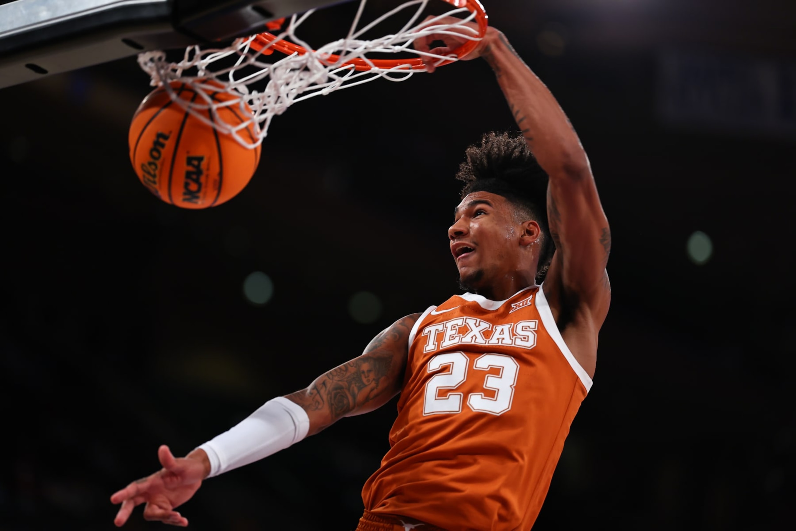 NEW YORK, NY - NOVEMBER 19:  Dillon Mitchell #23 of the Texas Longhorns dunks during the Empire Classic college basketball game against the Louisville Cardinals on November 19, 2023 at Madison Square Garden, New York, New York.   (Photo by Rich Graessle/Icon Sportswire via Getty Images)