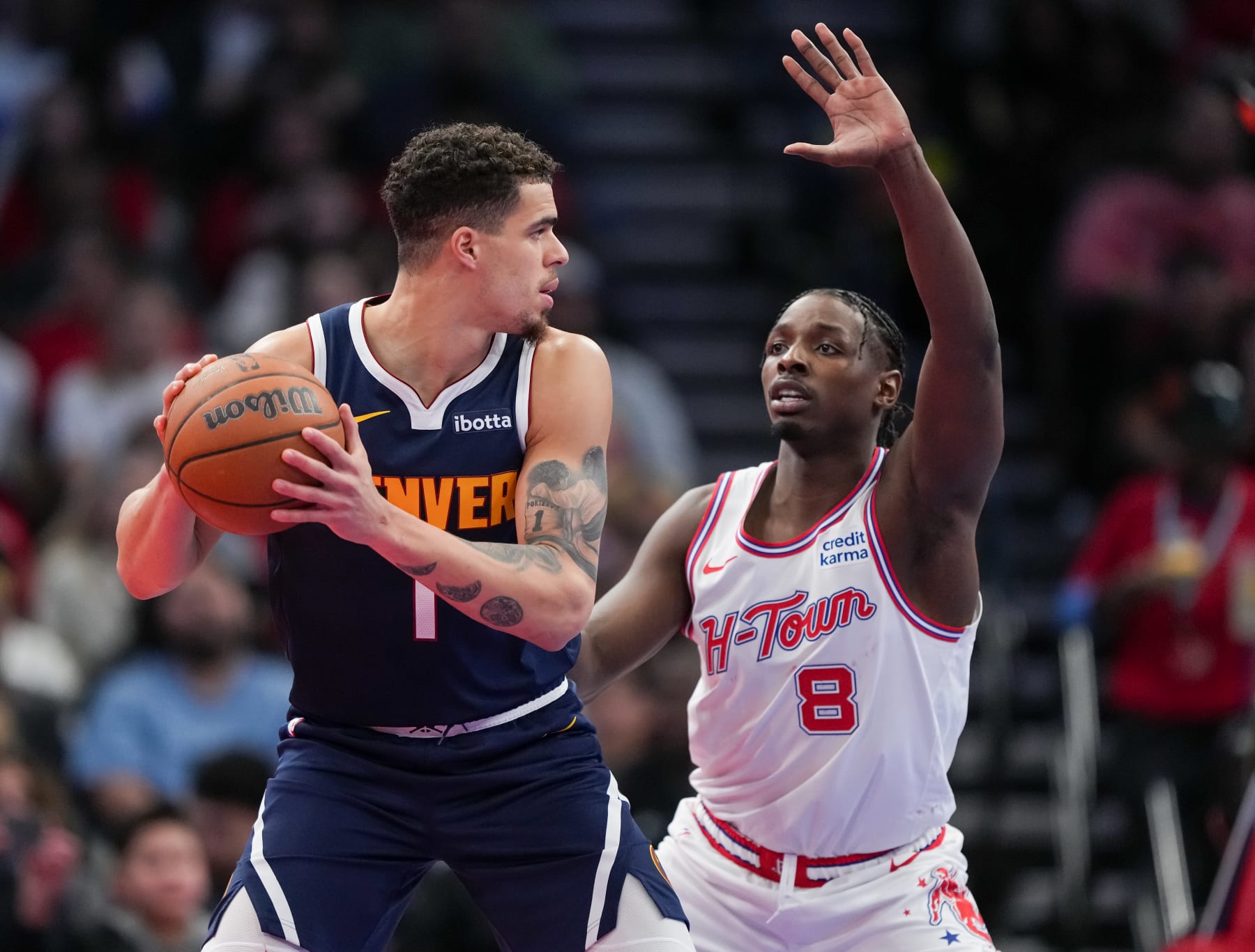 HOUSTON, TEXAS - NOVEMBER 24: Michael Porter Jr. #1 of the Denver Nuggets holds the ball as Jae'Sean Tate #8 of the Houston Rockets defends during an NBA In-Season Tournament game at Toyota Center on November 24, 2023 in Houston, Texas. NOTE TO USER: User expressly acknowledges and agrees that, by downloading and or using this photograph, User is consenting to the terms and conditions of the Getty Images License Agreement. (Photo by Alex Bierens de Haan/Getty Images)