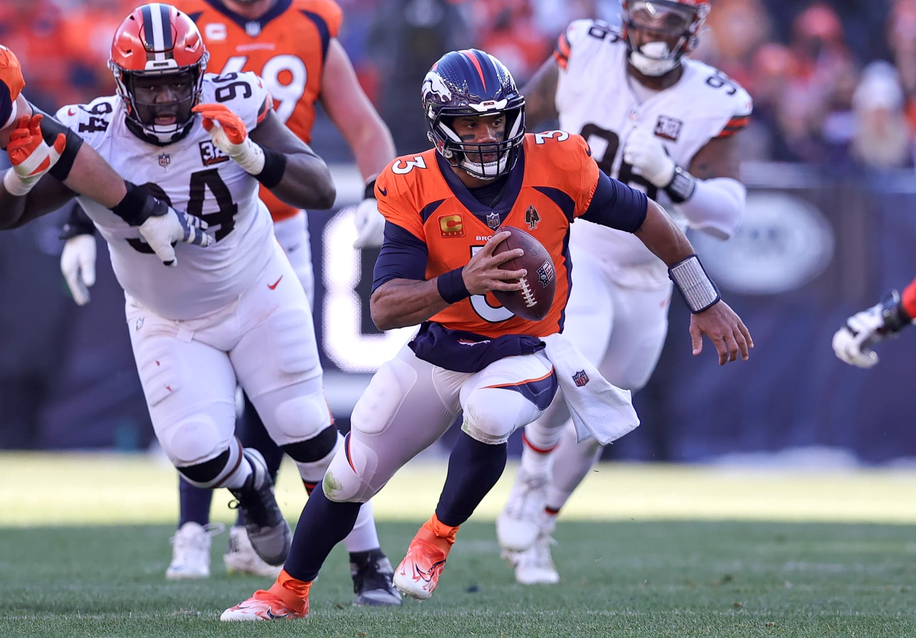 DENVER, CO - NOVEMBER 26: Denver Broncos quarterback Russell Wilson scrambles for a first down during an NFL game between the Cleveland Browns and the Denver Broncos on November 26, 2023 at Empower Field at Mile High in Denver, CO. (Photo by Steve Nurenberg/Icon Sportswire via Getty Images)