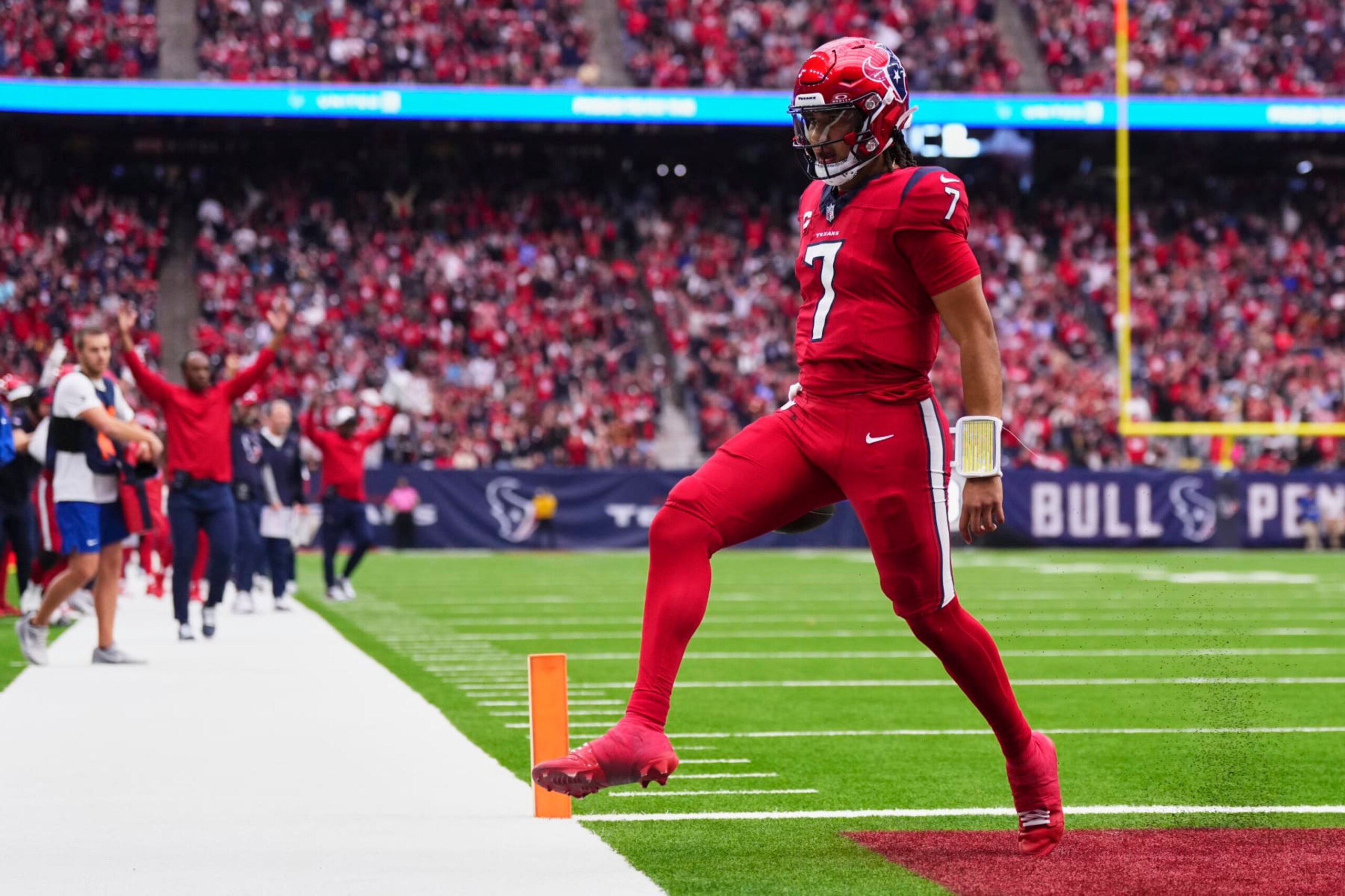 HOUSTON, TX - NOVEMBER 26: C.J. Stroud #7 of the Houston Texans rushes for a touchdown against the Jacksonville Jaguars during the second half at NRG Stadium on November 26, 2023 in Houston, Texas. (Photo by Cooper Neill/Getty Images)