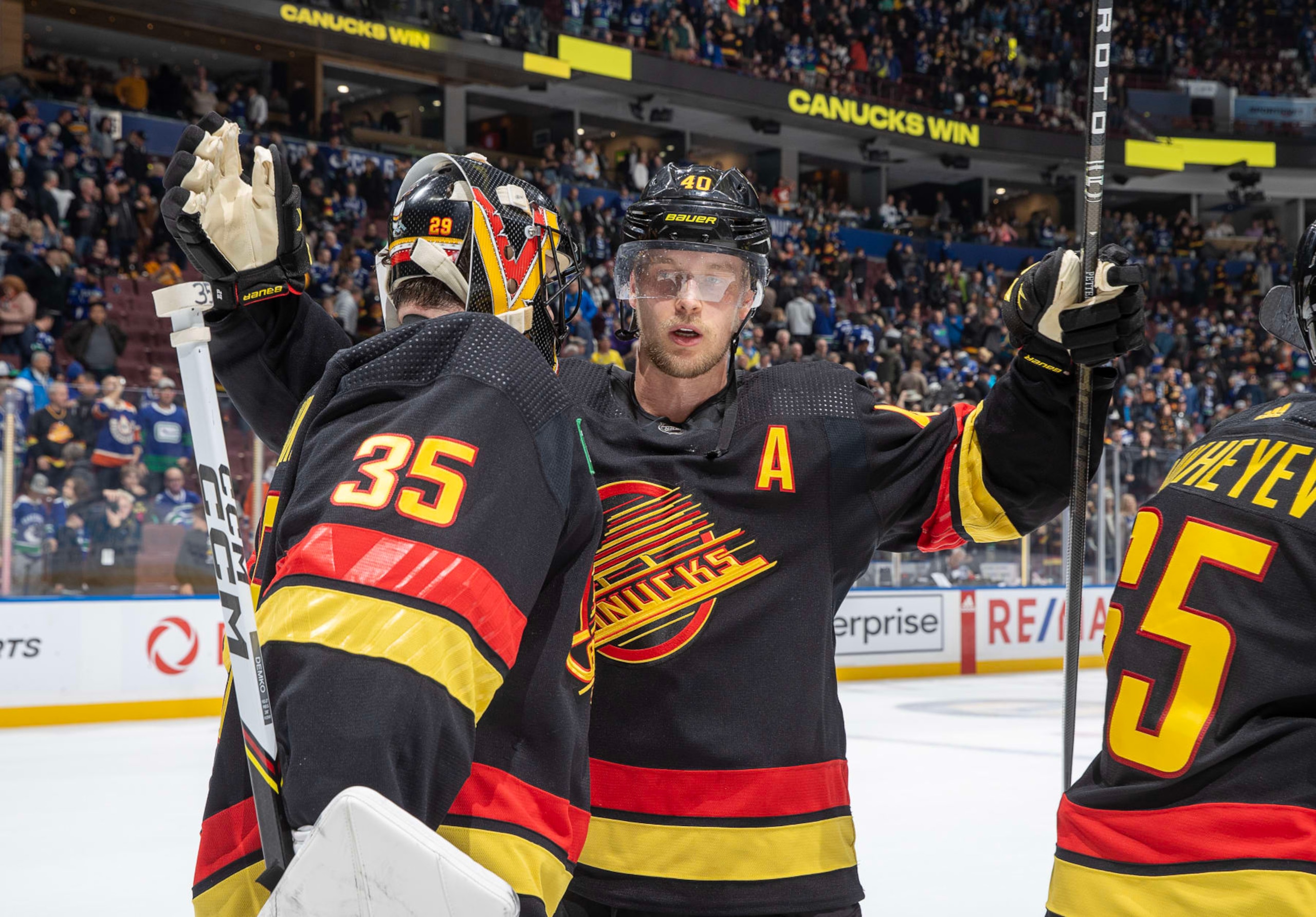 VANCOUVER, CANADA - NOVEMBER 6: Thatcher Demko #35 and Elias Pettersson #40 of the Vancouver Canucks celebrate their win after their NHL game against the Edmonton Oilers at Rogers Arena on November 6, 2023 in Vancouver, British Columbia, Canada. The Vancouver Canucks win 6-2 (Photo by Jeff Vinnick/NHLI via Getty Images)