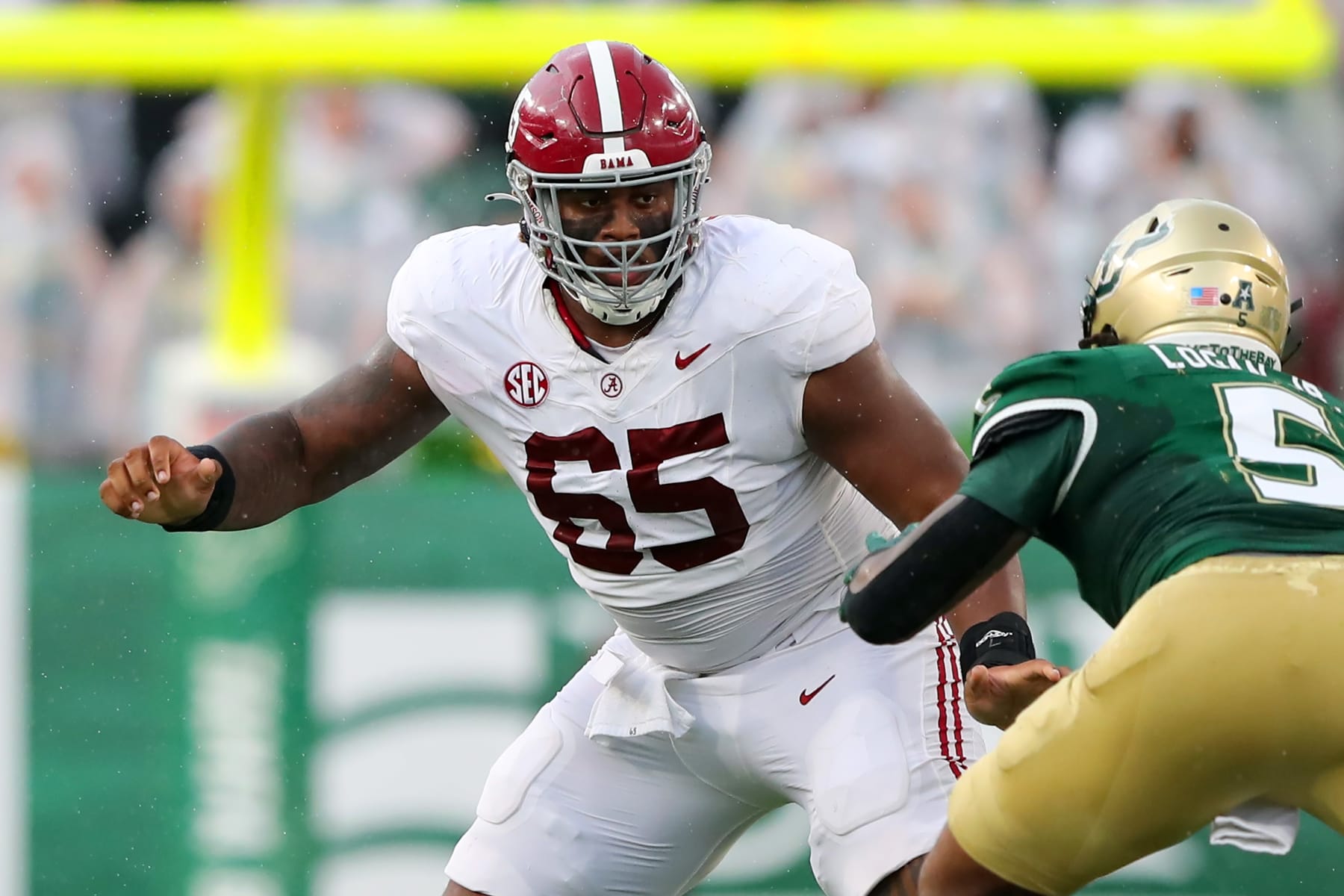 TAMPA, FL - SEPTEMBER 16: Alabama Offensive Lineman JC Latham (65) pass blocks during the College Football game between the Alabama Crimson Tide and the South Florida Bulls on September 16, 2023 at Raymond James Stadium in Tampa, FL. (Photo by Cliff Welch/Icon Sportswire via Getty Images)