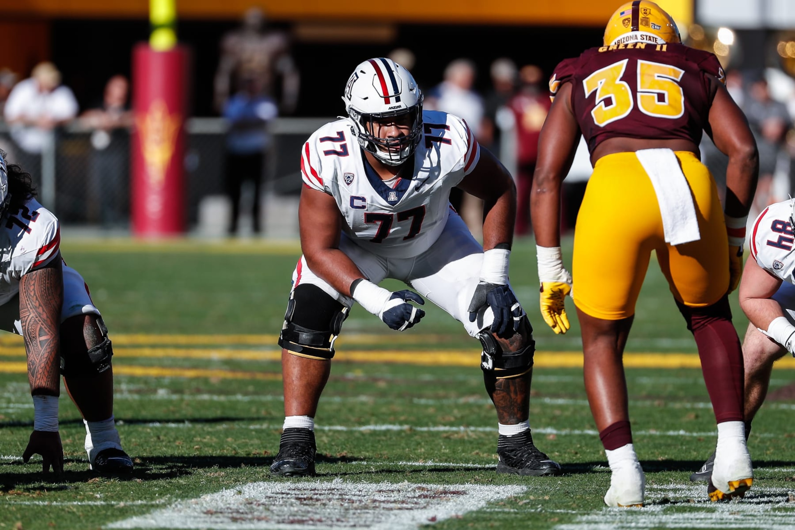 TEMPE, AZ - NOVEMBER 25: Arizona Wildcats offensive lineman Jordan Morgan (77) line up during the college football game between the Arizona Wildcats and the Arizona State Sun Devils on November 25, 2023 at Mountain America Stadium in Tempe, Arizona. (Photo by Kevin Abele/Icon Sportswire via Getty Images) TEMPE, AZ - NOVEMBER 25: Arizona Wildcats offensive lineman Jordan Morgan (77) line up during the college football game between the Arizona Wildcats and the Arizona State Sun Devils on November 25, 2023 at Mountain America Stadium in Tempe, Arizona. (Photo by Kevin Abele/Icon Sportswire via Getty Images)