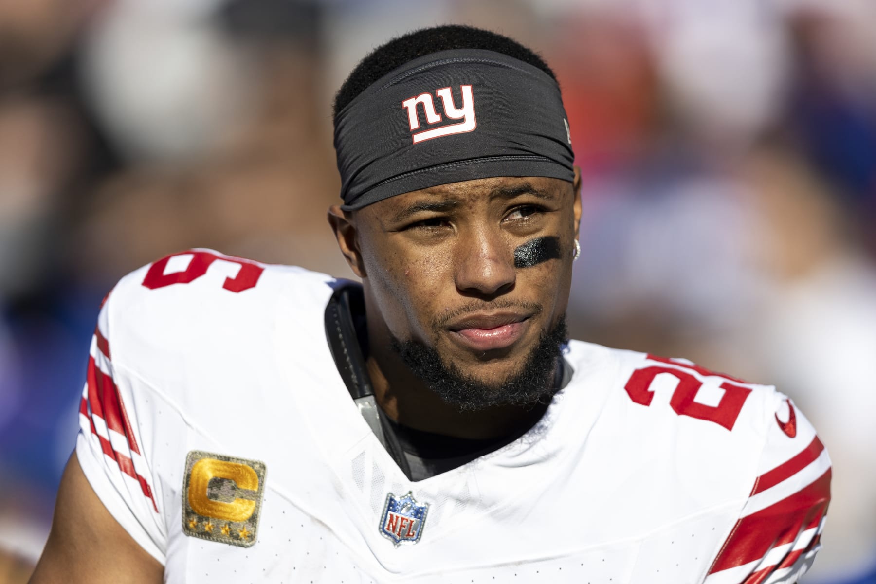 LANDOVER, MARYLAND - NOVEMBER 19: Saquon Barkley #26 of the New York Giants looks on during the national anthem prior to an NFL football game between the Washington Commanders and the New York Giants at FedExField on November 19, 2023 in Landover, Maryland. (Photo by Michael Owens/Getty Images)