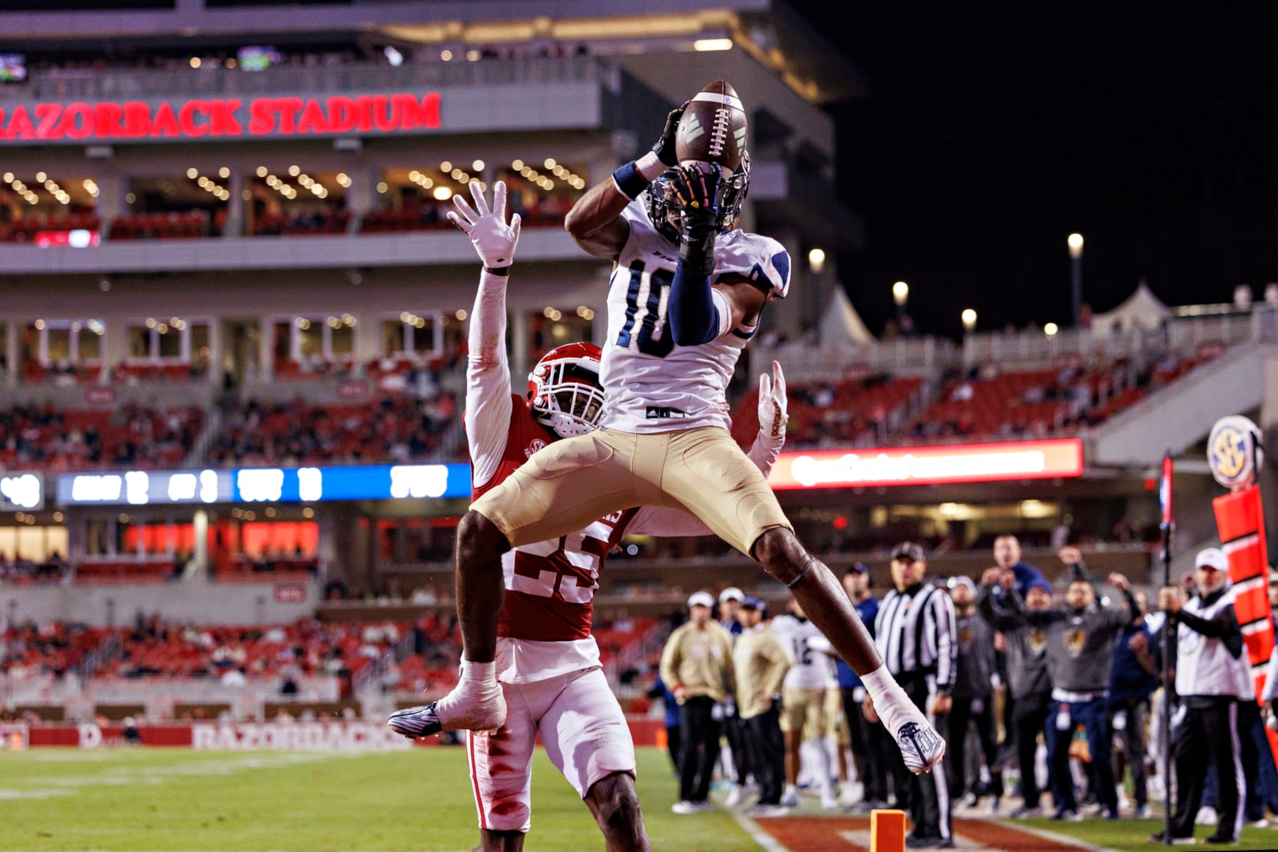 FAYETTEVILLE, ARKANSAS - NOVEMBER 18:  Kris Mitchell #10 of the FIU Panthers catches a touchdown pass over Keeyon Stewart #25 of the Arkansas Razorbacks at Donald W. Reynolds Razorback Stadium on November 18, 2023 in Fayetteville, Arkansas. The Razorbacks defeated the Panthers 44-20. (Photo by Wesley Hitt/Getty Images)