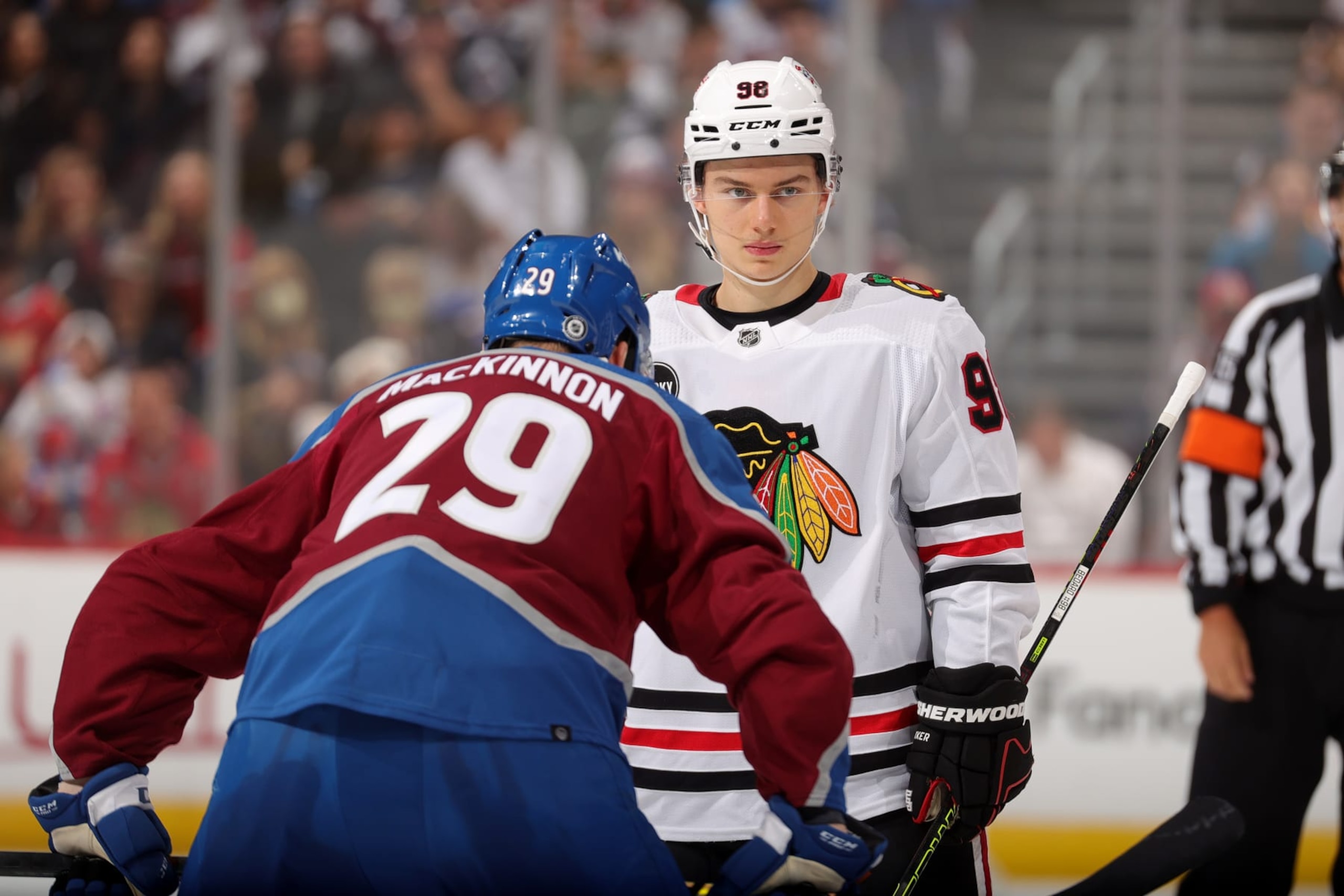 DENVER, COLORADO - OCTOBER 19: Nathan MacKinnon #29 of the Colorado Avalanche faces off against Connor Bedard #98 of the Chicago Blackhawks at Ball Arena on October 19, 2023 in Denver, Colorado. (Photo by Michael Martin/NHLI via Getty Images)