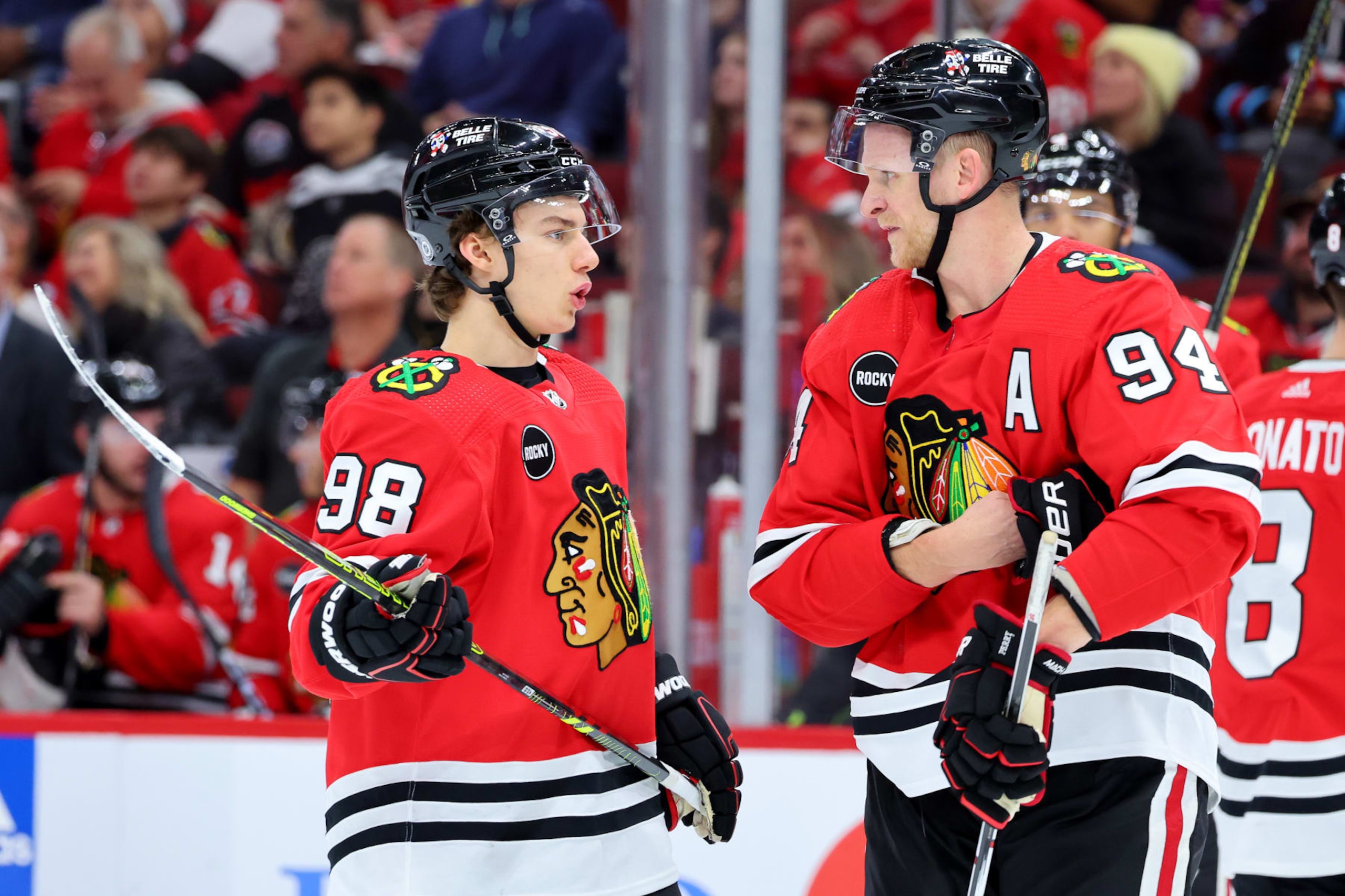 CHICAGO, ILLINOIS - OCTOBER 21: Connor Bedard #98 and Corey Perry #94 of the Chicago Blackhawks talk against the Vegas Golden Knights during the second period at the United Center on October 21, 2023 in Chicago, Illinois. (Photo by Michael Reaves/Getty Images)