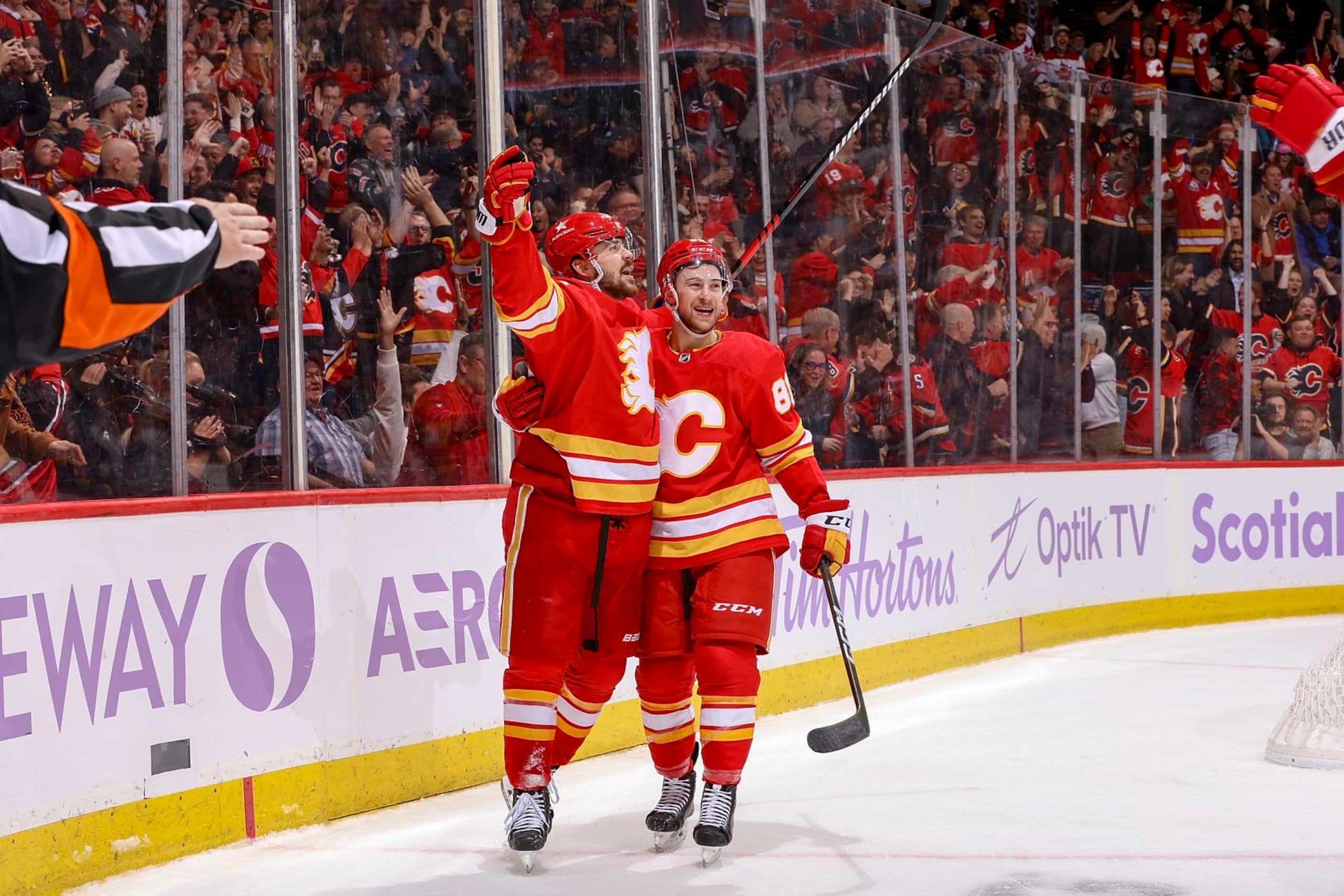 CALGARY, AB - NOVEMBER 27: MacKenzie Weegar #52 and Andrew Mangiapane #88 of the Calgary Flames celebrate on ice after a goal against the Vegas Golden Knights at Scotiabank Saddledome on November 27, 2023 in Calgary, Alberta, Canada. (Photo by Gerry Thomas/NHLI via Getty Images)