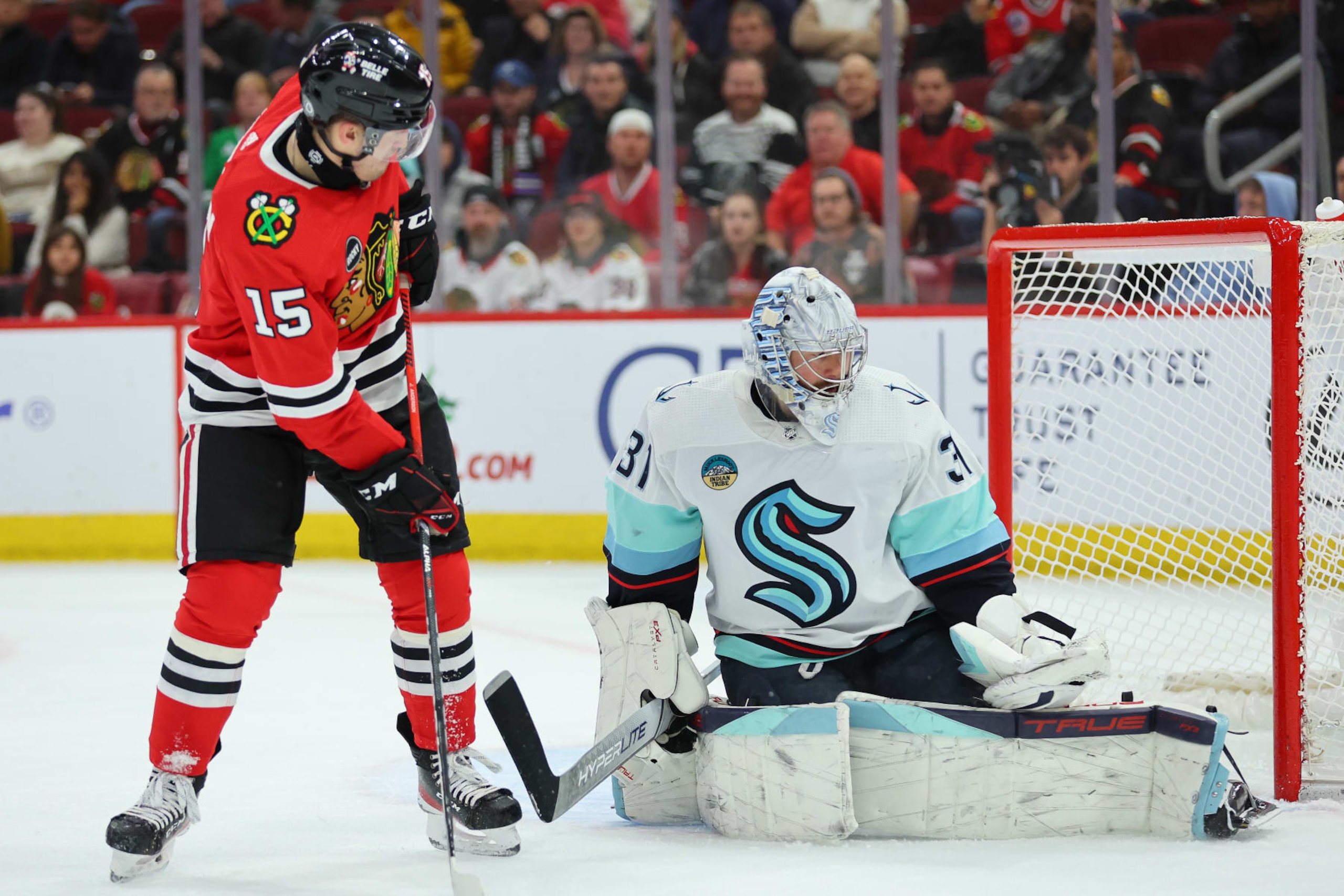 CHICAGO, ILLINOIS - NOVEMBER 28: Philipp Grubauer #31 of the Seattle Kraken makes a save against Joey Anderson #15 of the Chicago Blackhawks during the second period at the United Center on November 28, 2023 in Chicago, Illinois. (Photo by Michael Reaves/Getty Images)