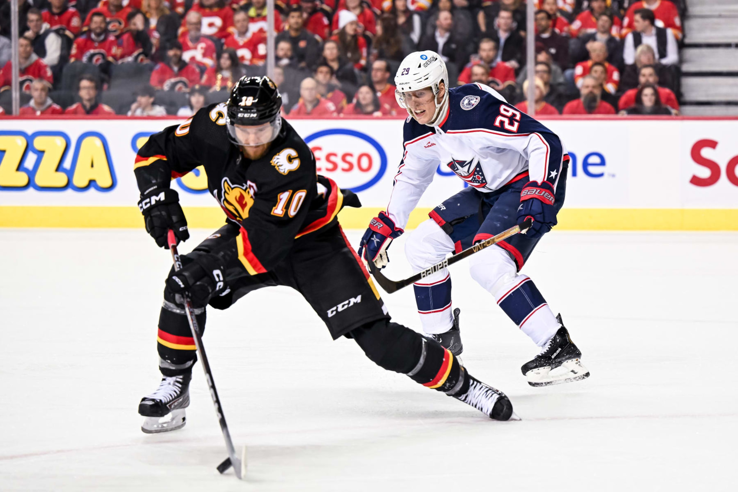 Calgary Flames left wing Jonathan Huberdeau (left) and Columbus Blue Jackets forward Patrik Laine. 