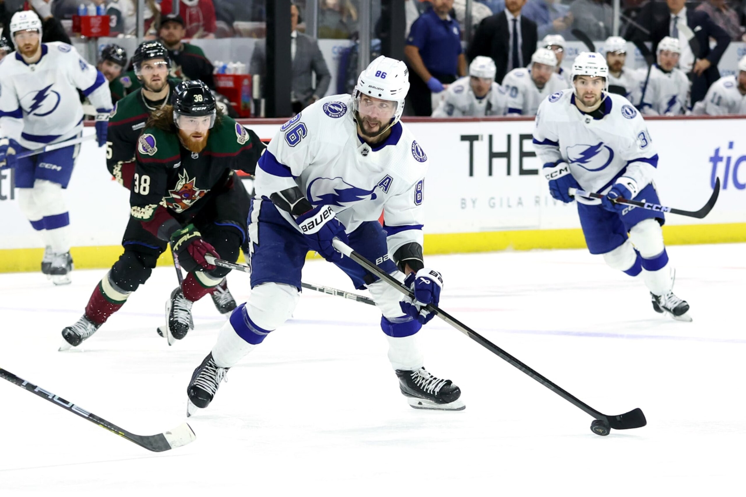 TEMPE, ARIZONA - NOVEMBER 28: Nikita Kucherov #86 of the Tampa Bay Lightning skates with the puck against Liam O'Brien #38 of the Arizona Coyotes during the third period at Mullett Arena on November 28, 2023 in Tempe, Arizona. (Photo by Zac BonDurant/Getty Images)