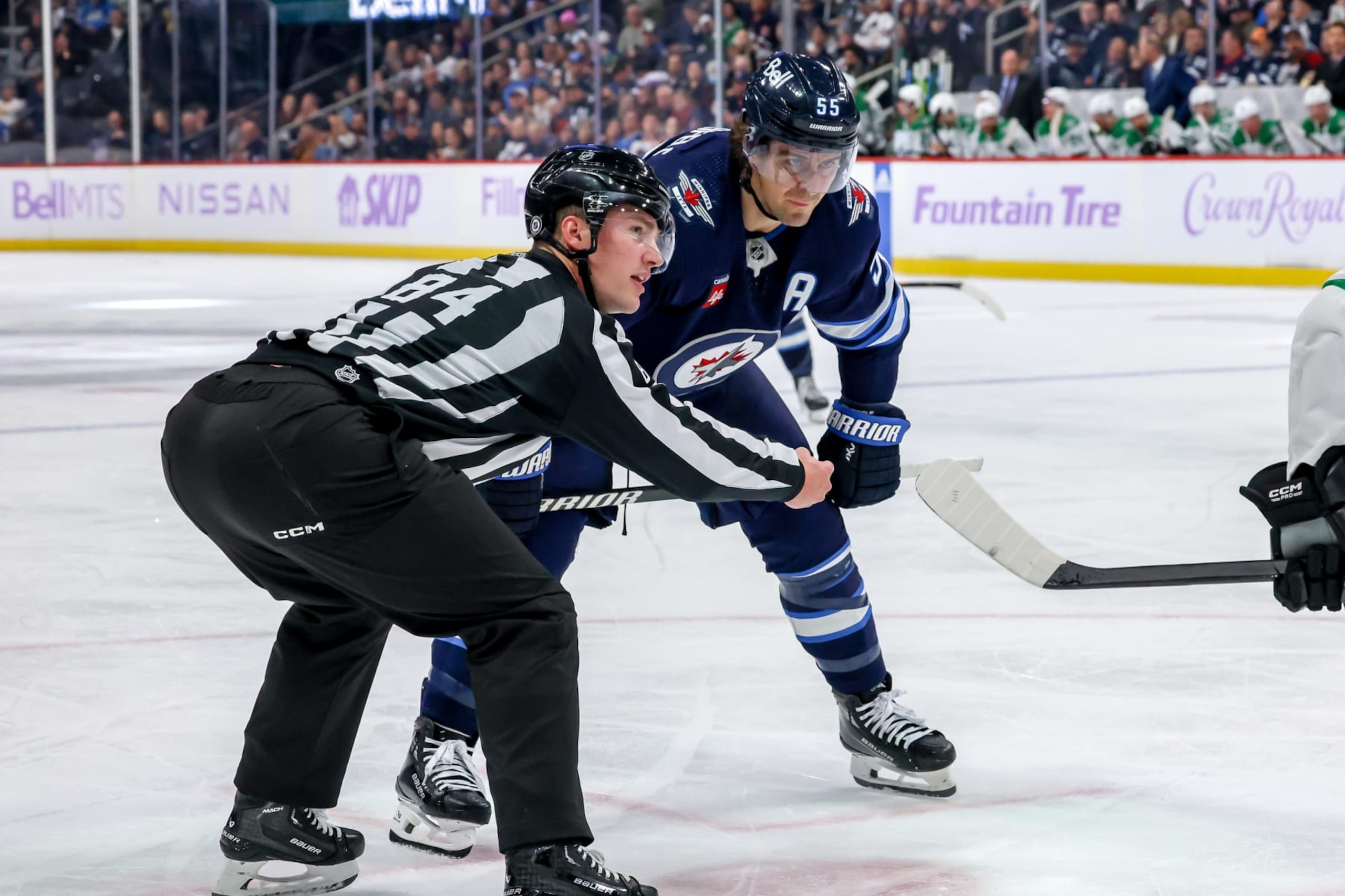 WINNIPEG, CANADA - NOVEMBER 28: Mark Scheifele #55 of the Winnipeg Jets looks on as he gets set to take a second period face-off against the Dallas Stars at the Canada Life Centre on November 28, 2023 in Winnipeg, Manitoba, Canada. (Photo by Jonathan Kozub/NHLI via Getty Images)