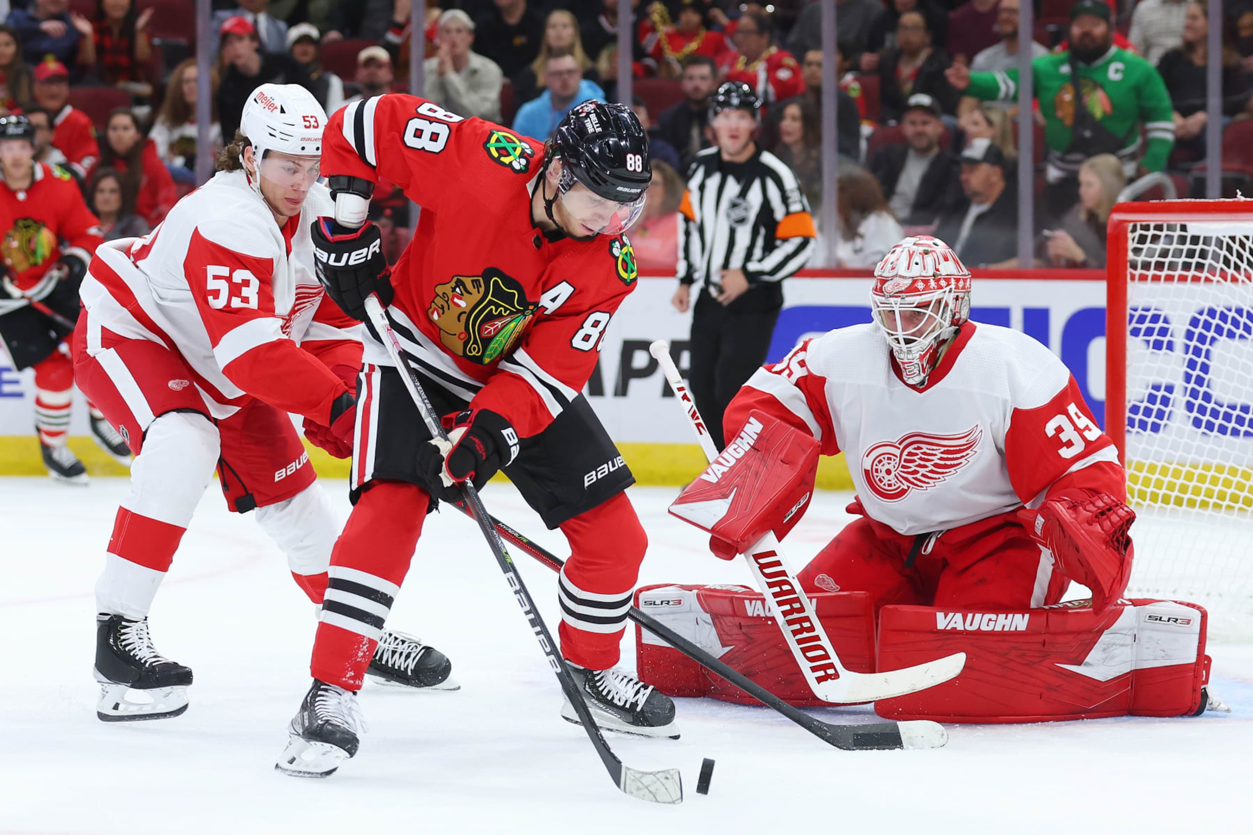 CHICAGO, ILLINOIS - OCTOBER 21: Patrick Kane #88 of the Chicago Blackhawks shot is defended by Alex Nedeljkovic #39 of the Detroit Red Wings during the second period at United Center on October 21, 2022 in Chicago, Illinois. (Photo by Michael Reaves/Getty Images)