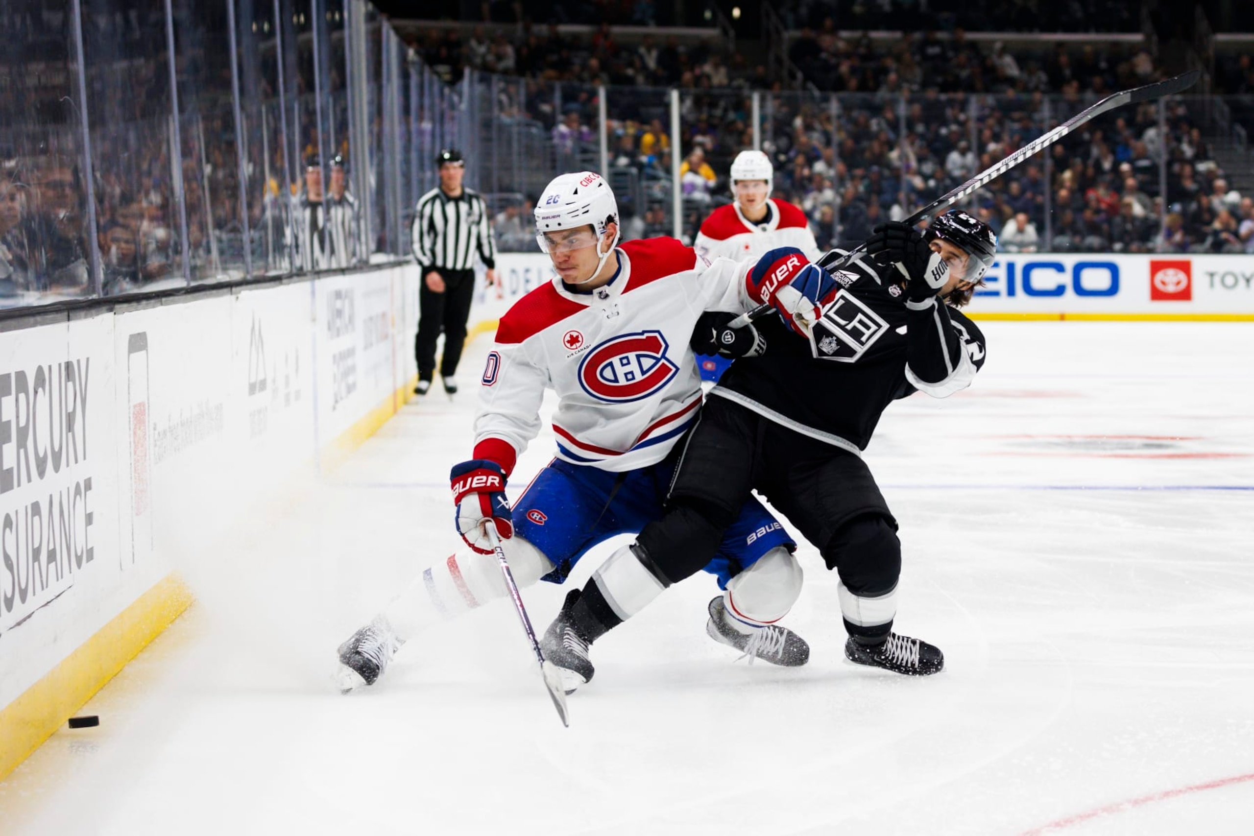 LOS ANGELES, CA - NOVEMBER 25: Montreal Canadiens left wing Juraj Slafkovsky (20) and Los Angeles Kings center Phillip Danault (24) battle for the puck during an NHL hockey game on November 25, 2023 at Crypto.com Arena in Los Angeles, CA. (Photo by Ric Tapia/Icon Sportswire via Getty Images)