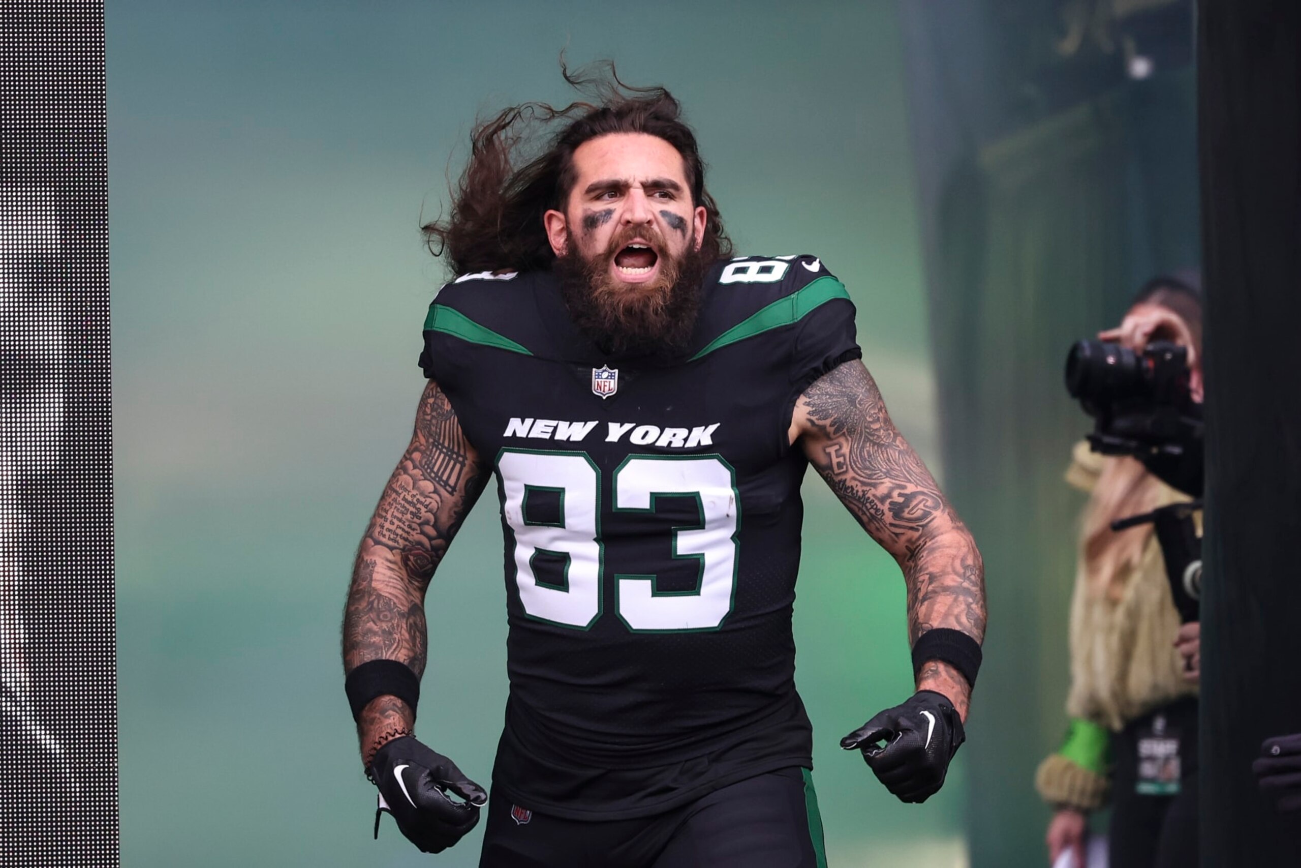 EAST RUTHERFORD, NJ - NOVEMBER 24: Tyler Conklin #83 of the New York Jets runs out of the tunnel prior to an NFL football game against the Miami Dolphins at MetLife Stadium on November 24, 2023 in East Rutherford, New Jersey. (Photo by Perry Knotts/Getty Images)
