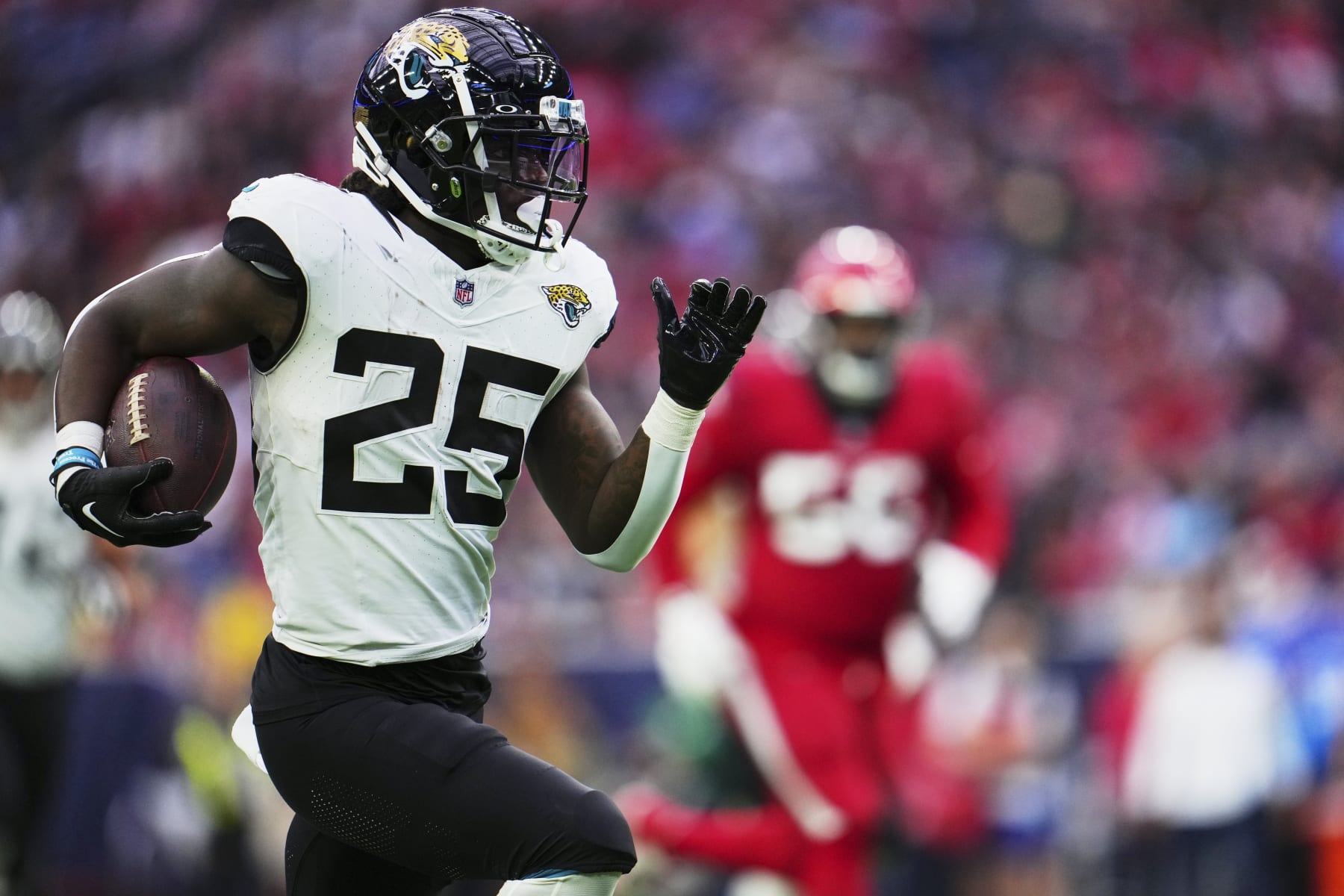HOUSTON, TX - NOVEMBER 26: D'Ernest Johnson #25 of the Jacksonville Jaguars carries the ball against the Houston Texans during the first half at NRG Stadium on November 26, 2023 in Houston, Texas. (Photo by Cooper Neill/Getty Images)