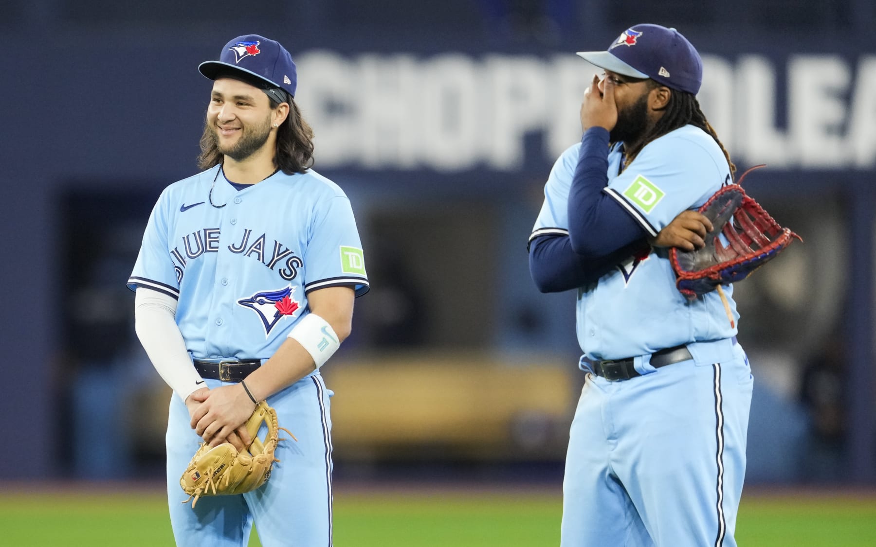 TORONTO, ON - SEPTEMBER 14: Bo Bichette #11 and Vladimir Guerrero Jr. #27 of Toronto Blue Jays smiles in a break in play against the Texas Rangers in their MLB game at the Rogers Centre on September 14, 2023 in Toronto, Ontario, Canada. (Photo by Mark Blinch/Getty Images)