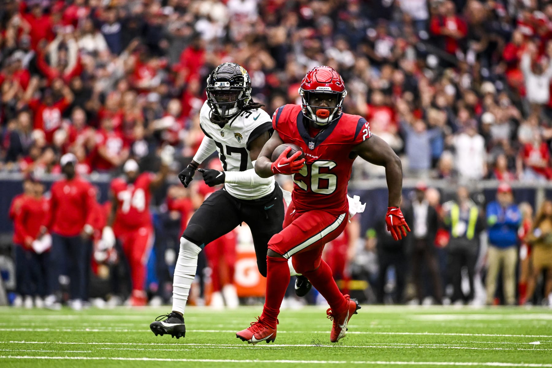 HOUSTON, TEXAS - NOVEMBER 26: Devin Singletary #26 of the Houston Texans runs the ball against the Jacksonville Jaguars at NRG Stadium on November 26, 2023 in Houston, Texas. (Photo by Logan Riely/Getty Images)