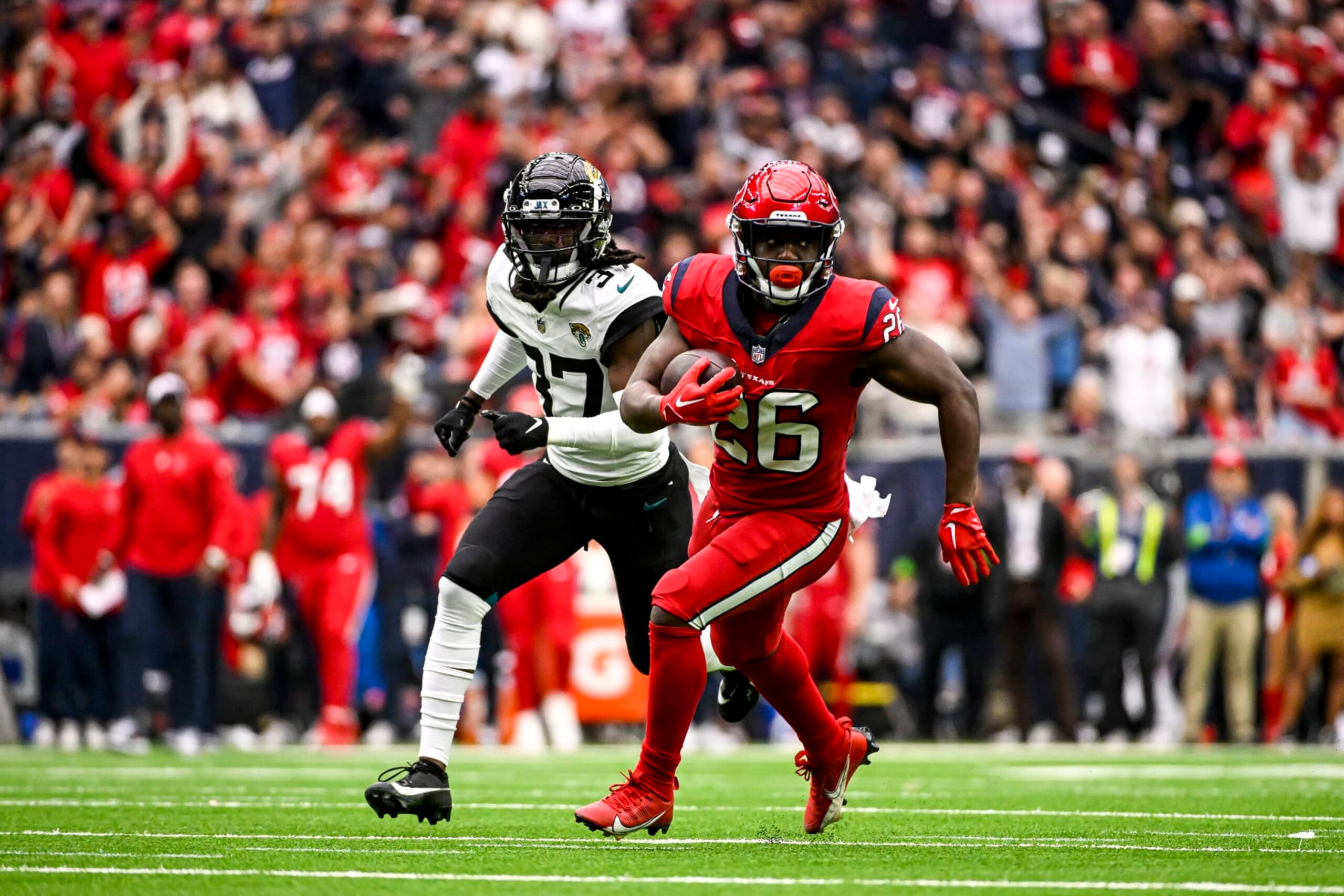 HOUSTON, TEXAS - NOVEMBER 26: Devin Singletary #26 of the Houston Texans runs the ball against the Jacksonville Jaguars at NRG Stadium on November 26, 2023 in Houston, Texas. (Photo by Logan Riely/Getty Images)