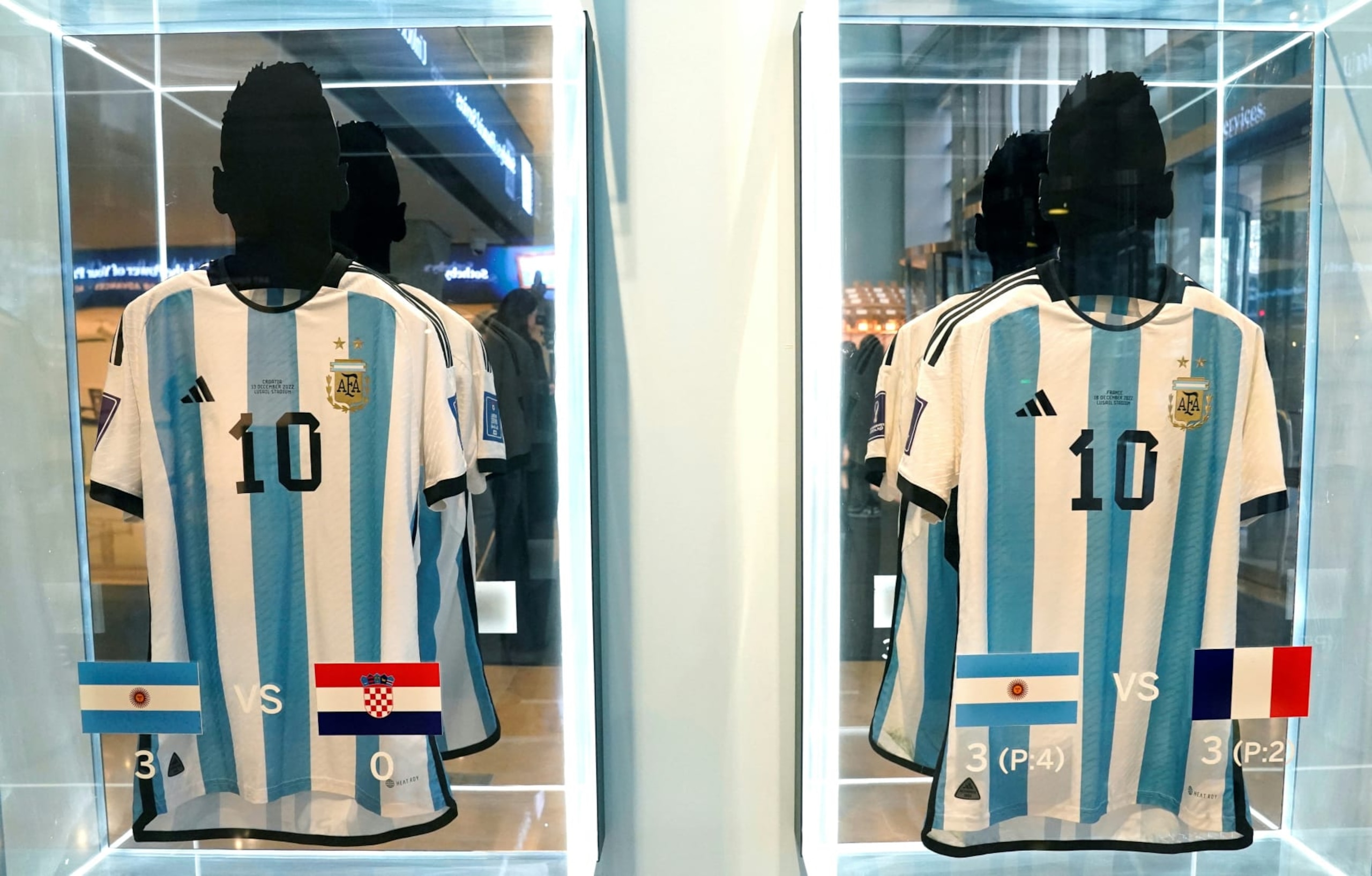 The shirt worn in the 2022 World Cup semi-final match between Argentina and Croatia on December 13, 2022 (L), and the shirt worn in the 2022 World Cup final match between Argentina and France on December 18, 2022 (R), are displayed during a Sotheby's auction media preview of six 2022 FIFA World Cup match-worn shirts belonging to Inter Miami's Argentine forward #10 Lionel Messi, in New York City on November 30, 2023. The auction, which includes shirts worn in the final, semi-final, quarter-final, round of 16, and key group stage matches, is open for bidding from November 30, 2023, to December 14, 2023. (Photo by TIMOTHY A. CLARY / AFP) (Photo by TIMOTHY A. CLARY/AFP via Getty Images)