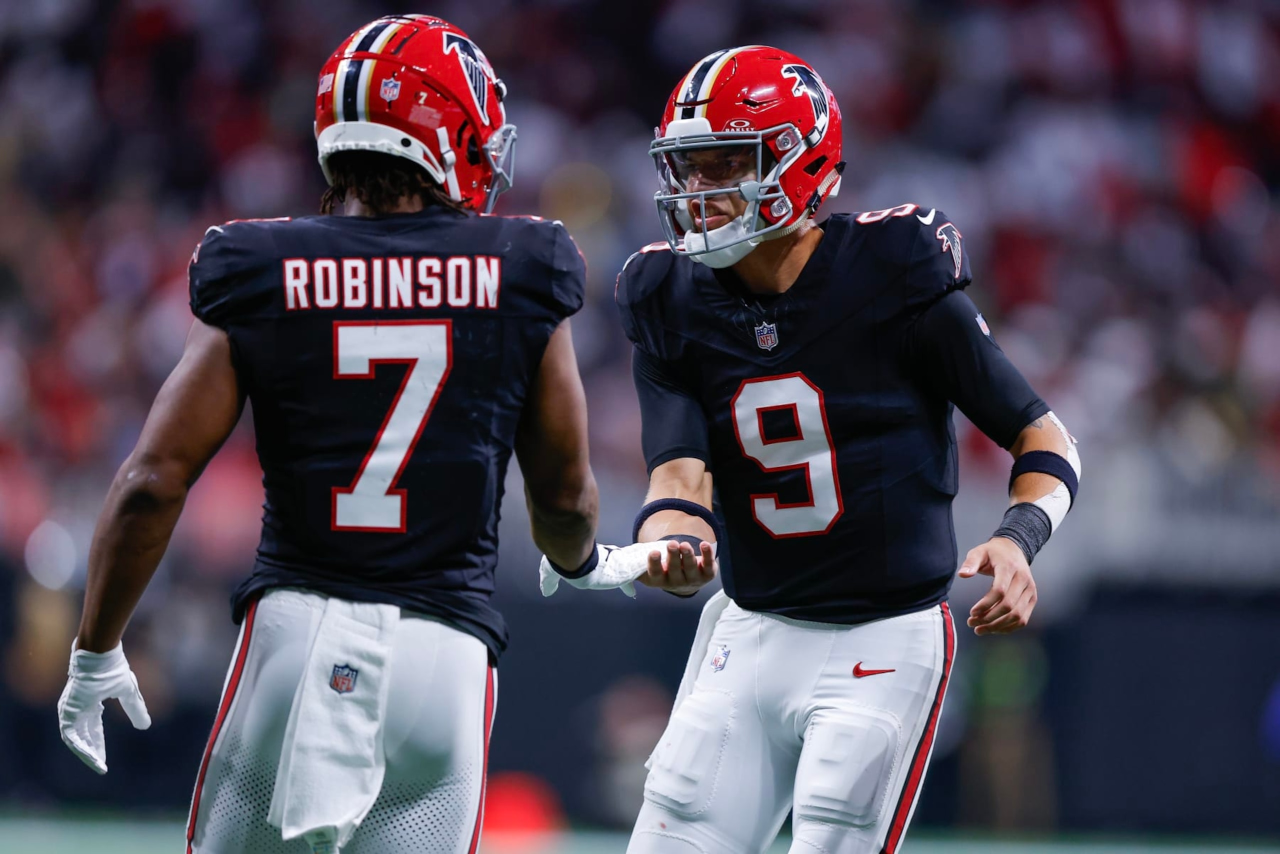 ATLANTA, GEORGIA - NOVEMBER 26: Bijan Robinson #7 of the Atlanta Falcons celebrates with Desmond Ridder #9 after scoring a touchdown in the second quarter of the game against the New Orleans Saints at Mercedes-Benz Stadium on November 26, 2023 in Atlanta, Georgia. (Photo by Todd Kirkland/Getty Images) ATLANTA, GEORGIA - NOVEMBER 26: Bijan Robinson #7 of the Atlanta Falcons celebrates with Desmond Ridder #9 after scoring a touchdown in the second quarter of the game against the New Orleans Saints at Mercedes-Benz Stadium on November 26, 2023 in Atlanta, Georgia. (Photo by Todd Kirkland/Getty Images)