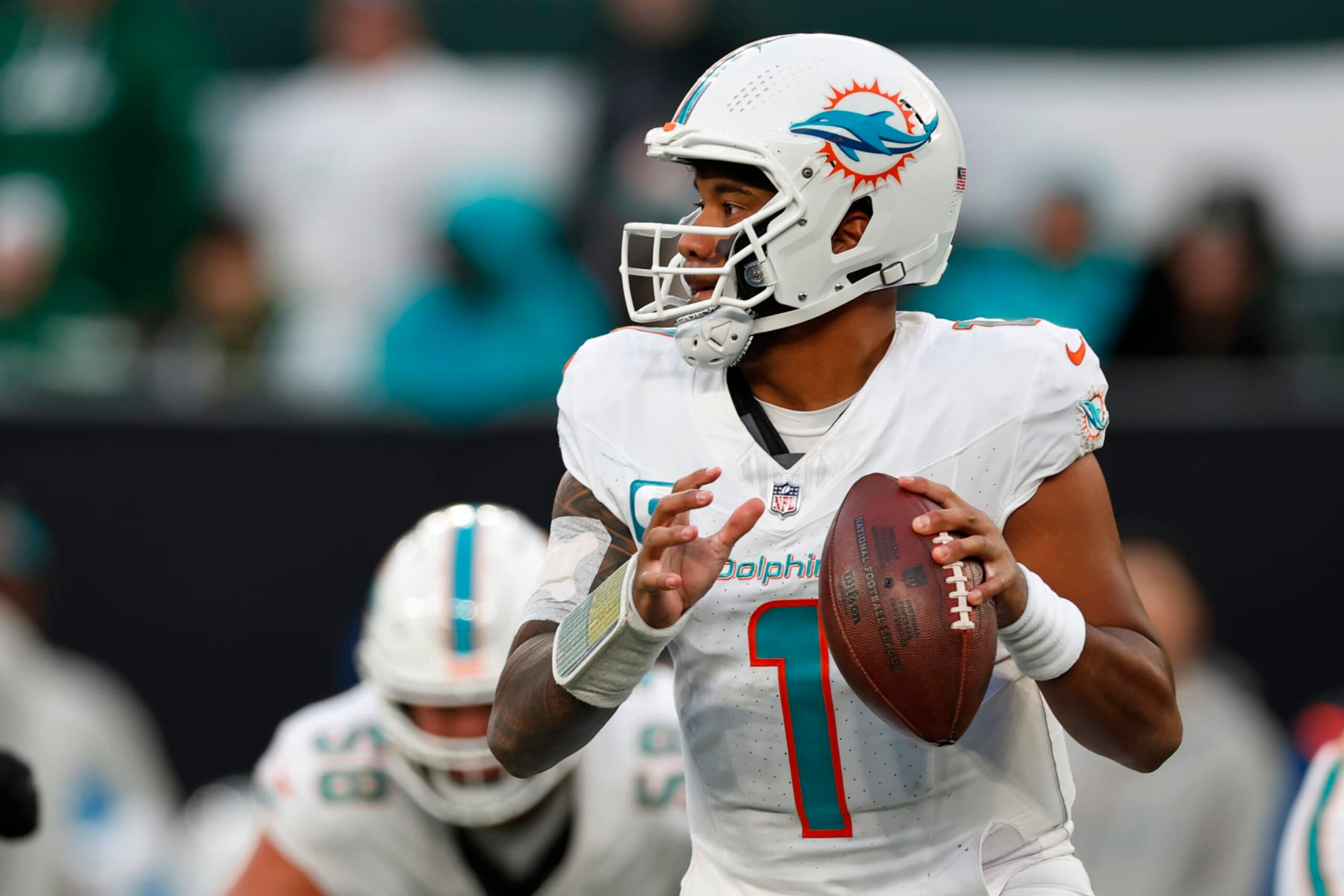 EAST RUTHERFORD, NEW JERSEY - NOVEMBER 24: Quarterback Tua Tagovailoa #1 of the Miami Dolphins in action against the New York Jets during a football game at MetLife Stadium on November 24, 2023 in East Rutherford, New Jersey. (Photo by Rich Schultz/Getty Images) EAST RUTHERFORD, NEW JERSEY - NOVEMBER 24: Quarterback Tua Tagovailoa #1 of the Miami Dolphins in action against the New York Jets during a football game at MetLife Stadium on November 24, 2023 in East Rutherford, New Jersey. (Photo by Rich Schultz/Getty Images)