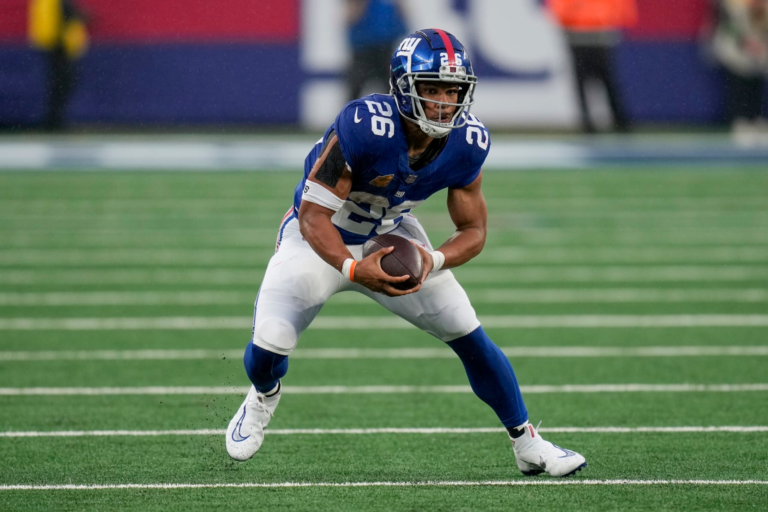 New York Giants running back Saquon Barkley (26) carries the ball against the New England Patriots during the fourth quarter of an NFL football game, Sunday, Nov. 26, 2023, in East Rutherford, N.J. (AP Photo/Seth Wenig)