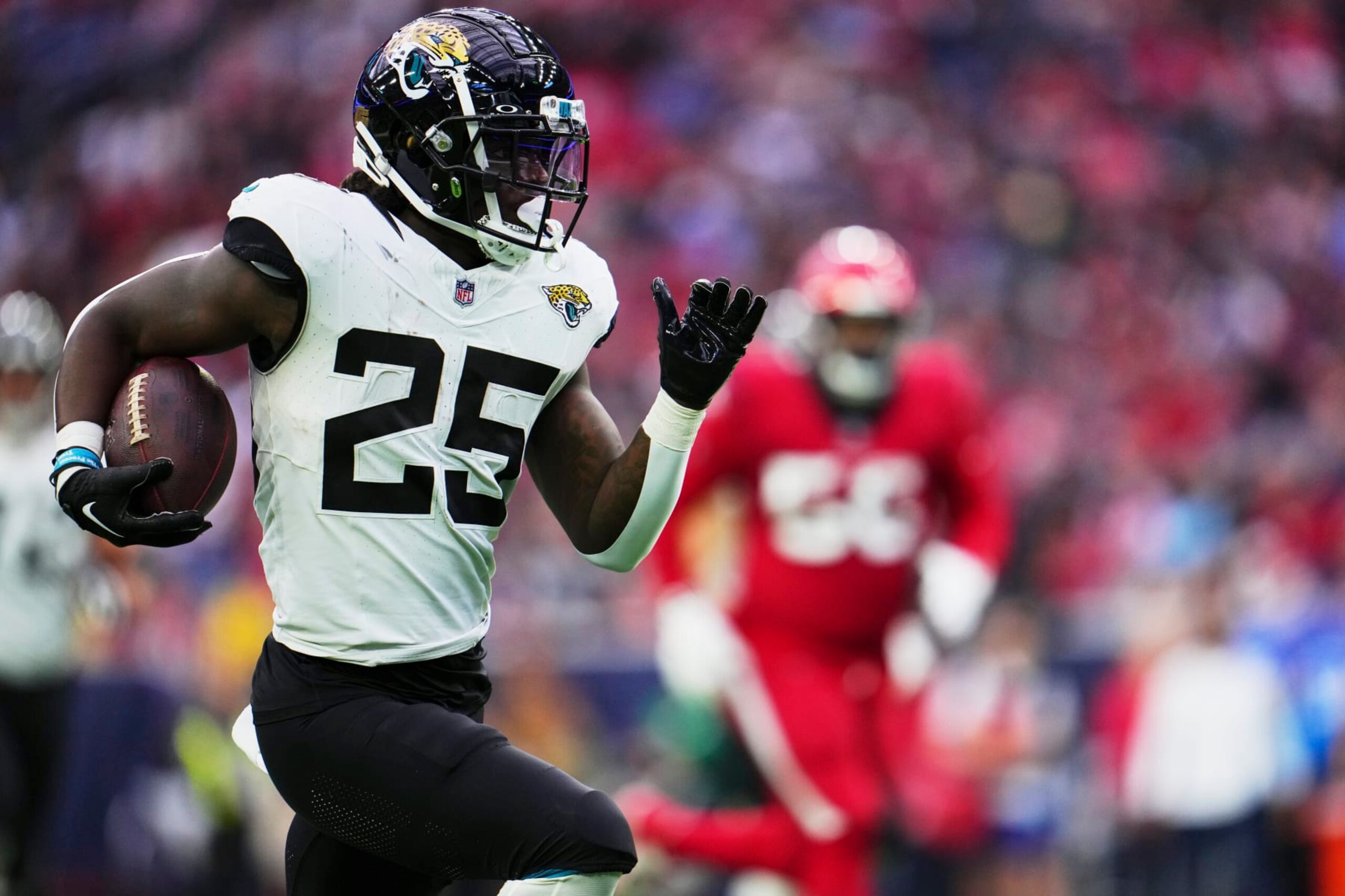 HOUSTON, TX - NOVEMBER 26: D'Ernest Johnson #25 of the Jacksonville Jaguars carries the ball against the Houston Texans during the first half at NRG Stadium on November 26, 2023 in Houston, Texas. (Photo by Cooper Neill/Getty Images)