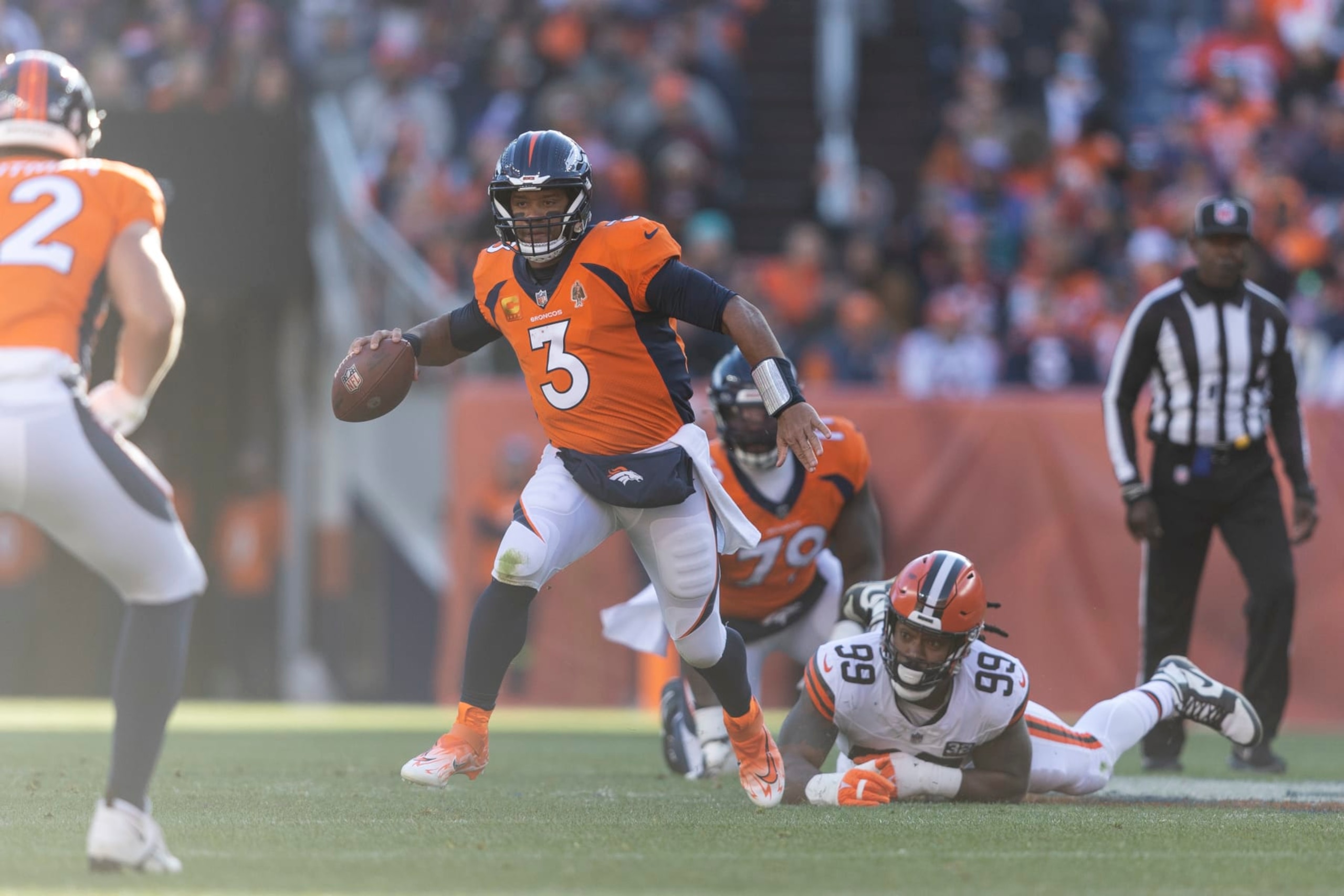 DENVER, COLORADO - NOVEMBER 26: Russell Wilson #3 of the Denver Broncos scrambles and runs with the ball during an NFL football game between the Denver Broncos and the Cleveland Browns at Empower Field At Mile High on November 26, 2023 in Denver, Colorado. (Photo by Michael Owens/Getty Images)