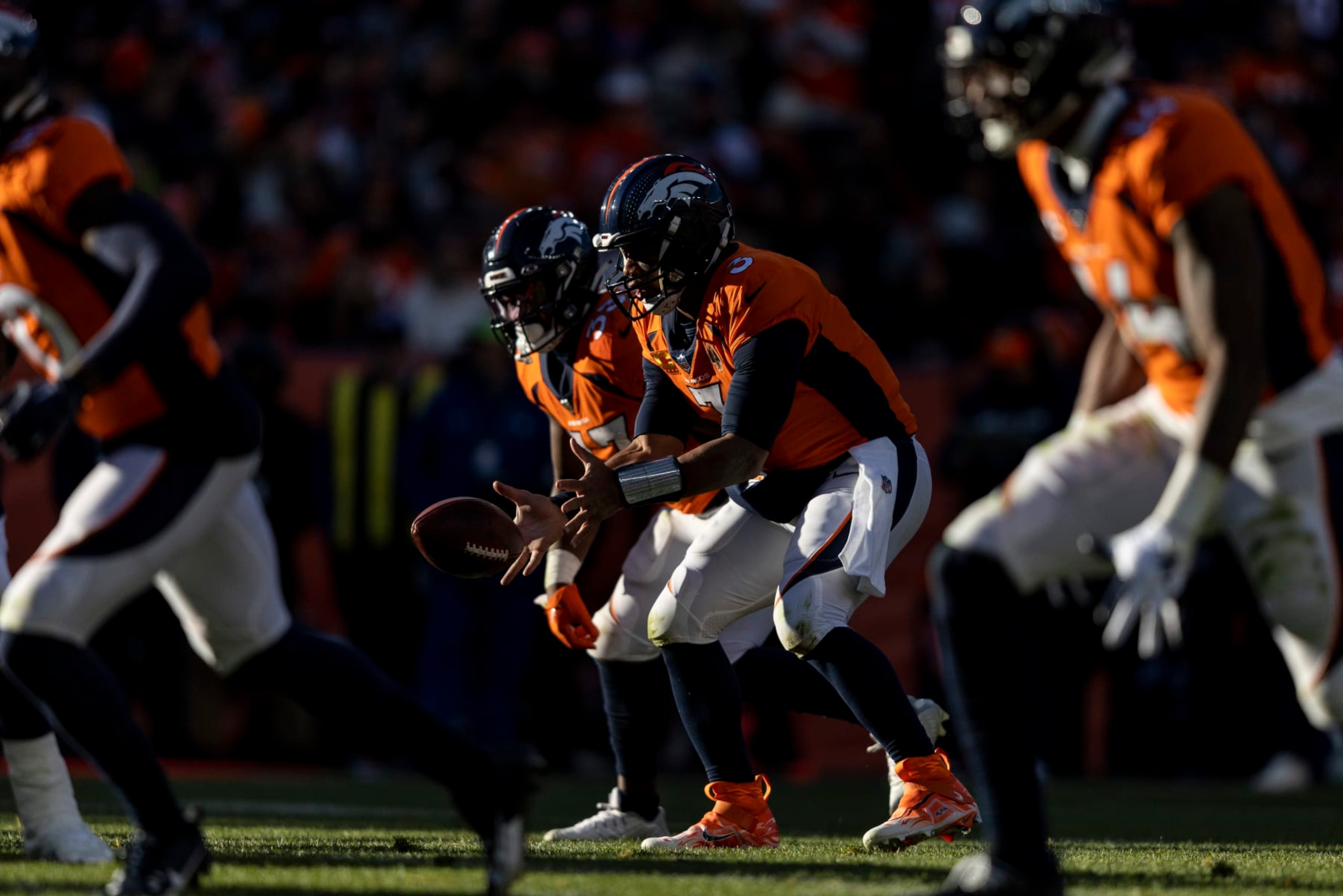 DENVER, COLORADO - NOVEMBER 26: Russell Wilson #3 of the Denver Broncos hikes the ball during an NFL football game between the Denver Broncos and the Cleveland Browns at Empower Field At Mile High on November 26, 2023 in Denver, Colorado. (Photo by Michael Owens/Getty Images)
