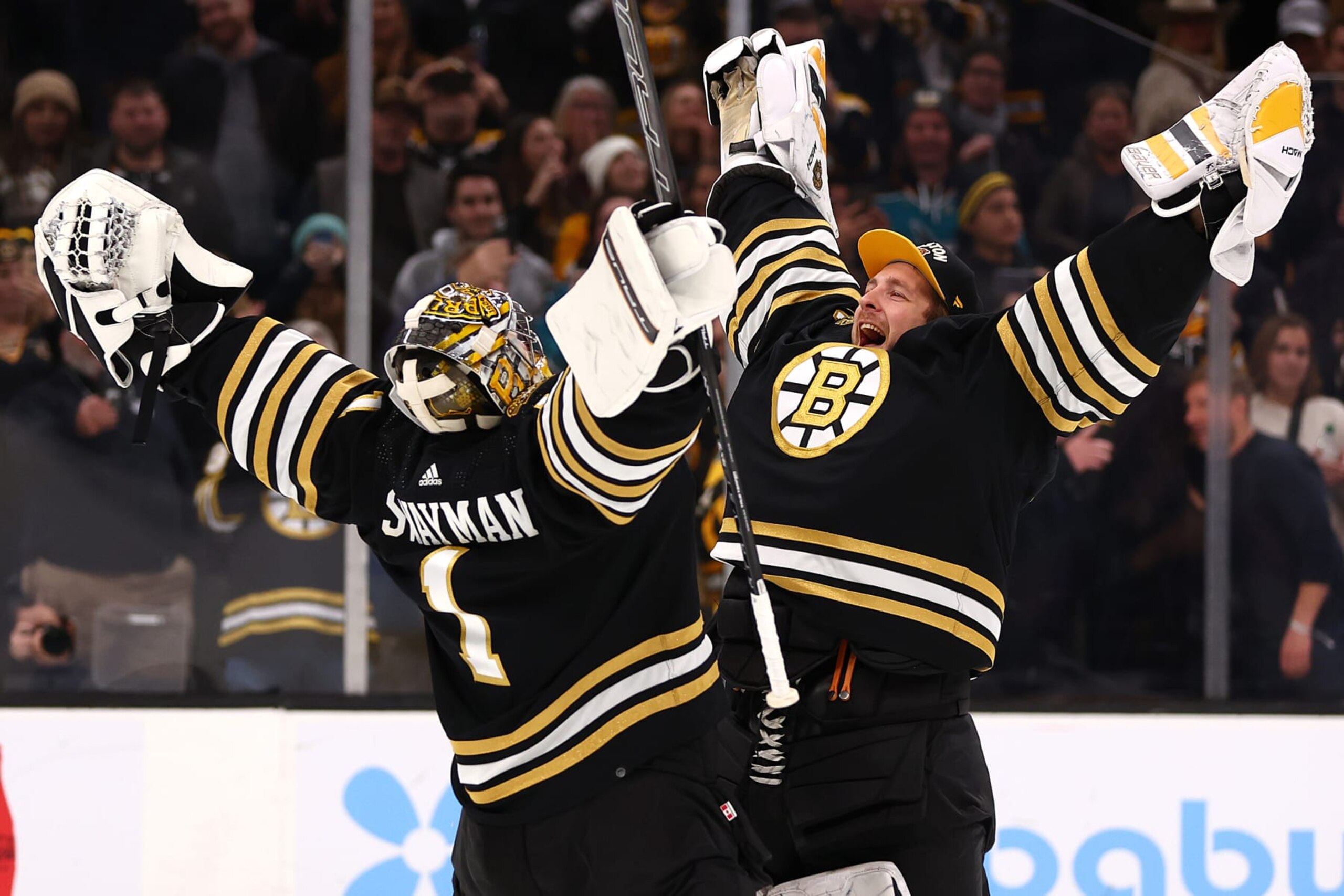 BOSTON, MASSACHUSETTS - NOVEMBER 30: Jeremy Swayman #1 of the Boston Bruins and Linus Ullmark #35 celebrate after the Bruins defeat the San Jose Sharks 3-0 at TD Garden on November 30, 2023 in Boston, Massachusetts. (Photo by Maddie Meyer/Getty Images)