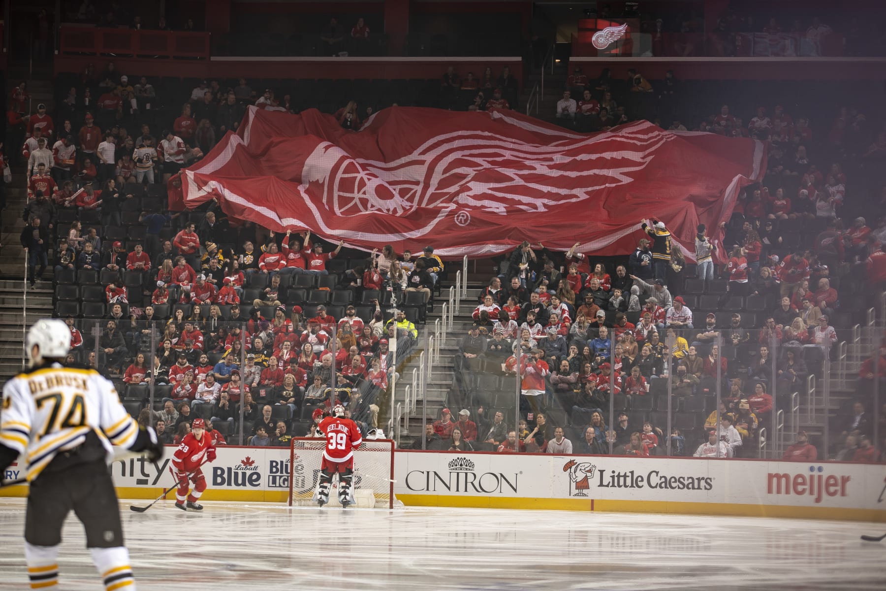 DETROIT, MI - APRIL 05: A large Detroit Red Wings flag is passed over the crowd before the first period of an NHL game against the Boston Bruins at Little Caesars Arena on April 5, 2022 in Detroit, Michigan. (Photo by Dave Reginek/NHLI via Getty Images)