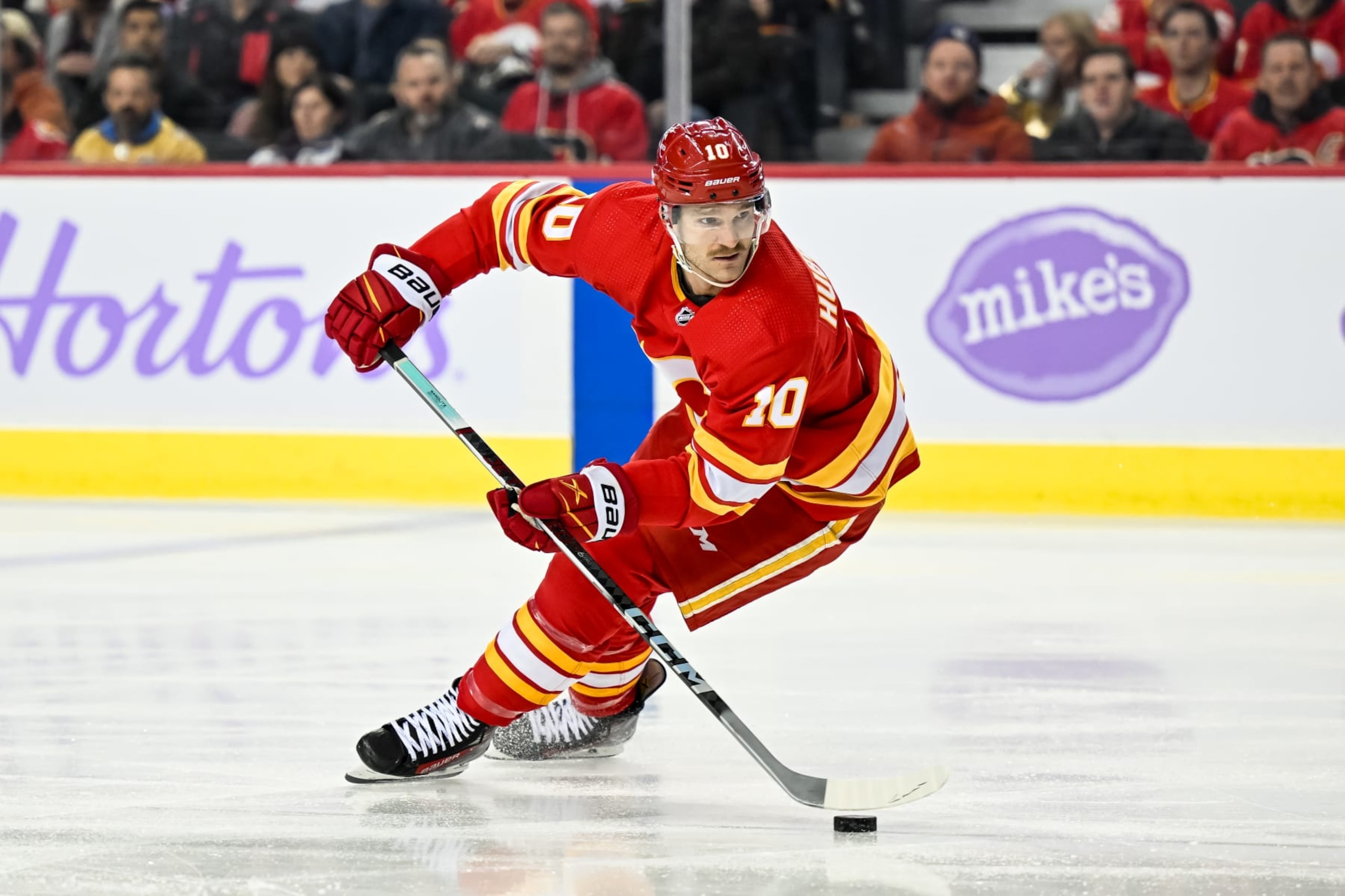 CALGARY, AB - NOVEMBER 27: Calgary Flames Left Wing Jonathan Huberdeau (10) skates with the puck during the first period of an NHL game between the Calgary Flames and the Vegas Golden Knights on November 27, 2023, at the Scotiabank Saddledome in Calgary, AB. (Photo by Brett Holmes/Icon Sportswire via Getty Images)