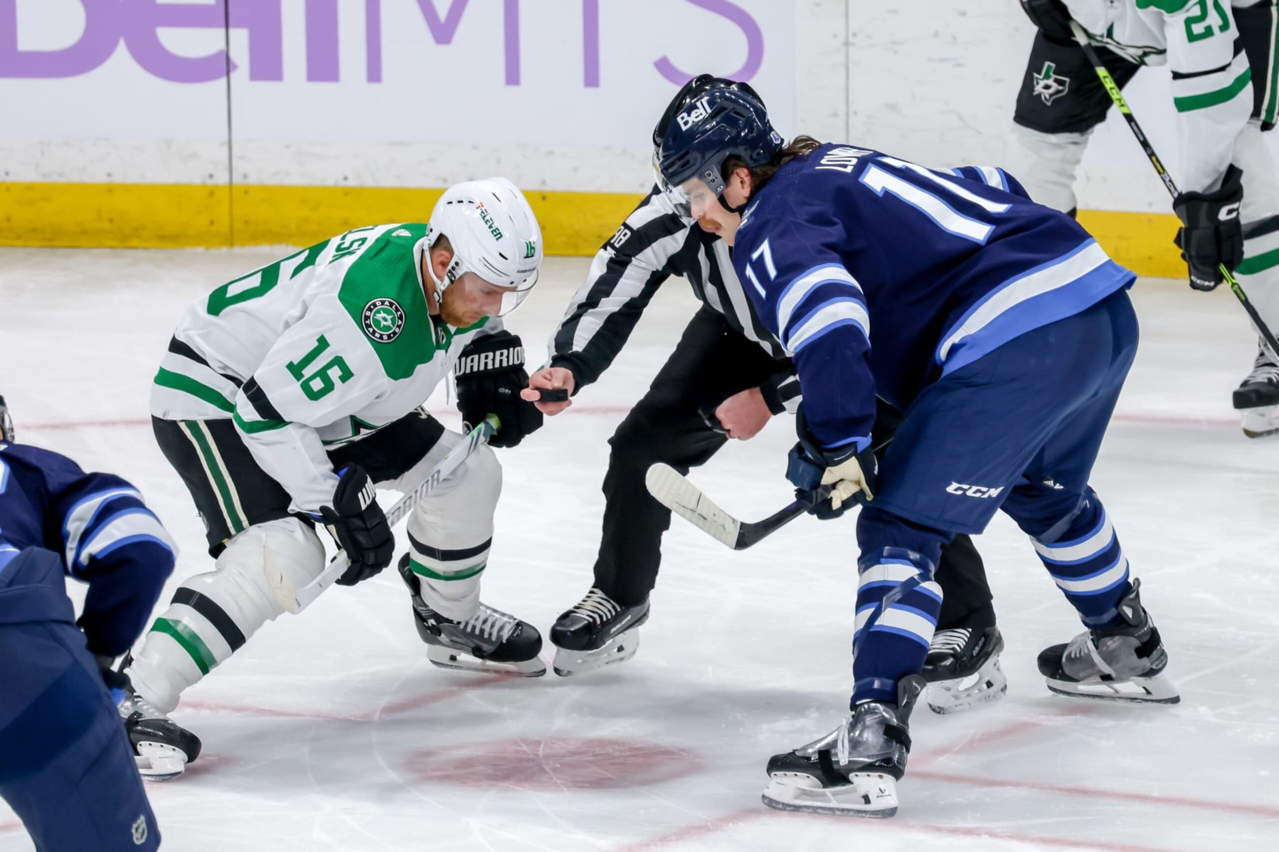 WINNIPEG, CANADA - NOVEMBER 28: Joe Pavelski #16 of the Dallas Stars and Adam Lowry #17 of the Winnipeg Jets get set for a first period face-off at the Canada Life Centre on November 28, 2023 in Winnipeg, Manitoba, Canada. (Photo by Jonathan Kozub/NHLI via Getty Images)