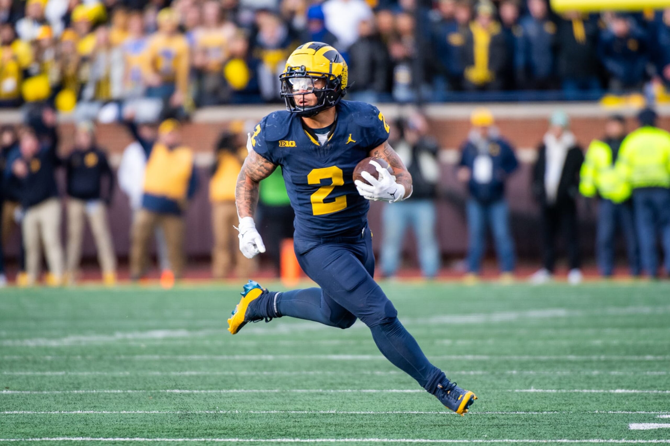 ANN ARBOR, MICHIGAN - NOVEMBER 25: Blake Corum #2 of the Michigan Wolverines runs with the ball for yardage during the second half of a college football game against the Ohio State Buckeyes at Michigan Stadium on November 25, 2023 in Ann Arbor, Michigan. The Michigan Wolverines won the game 30-24 to win the Big Ten East. (Photo by Aaron J. Thornton/Getty Images)