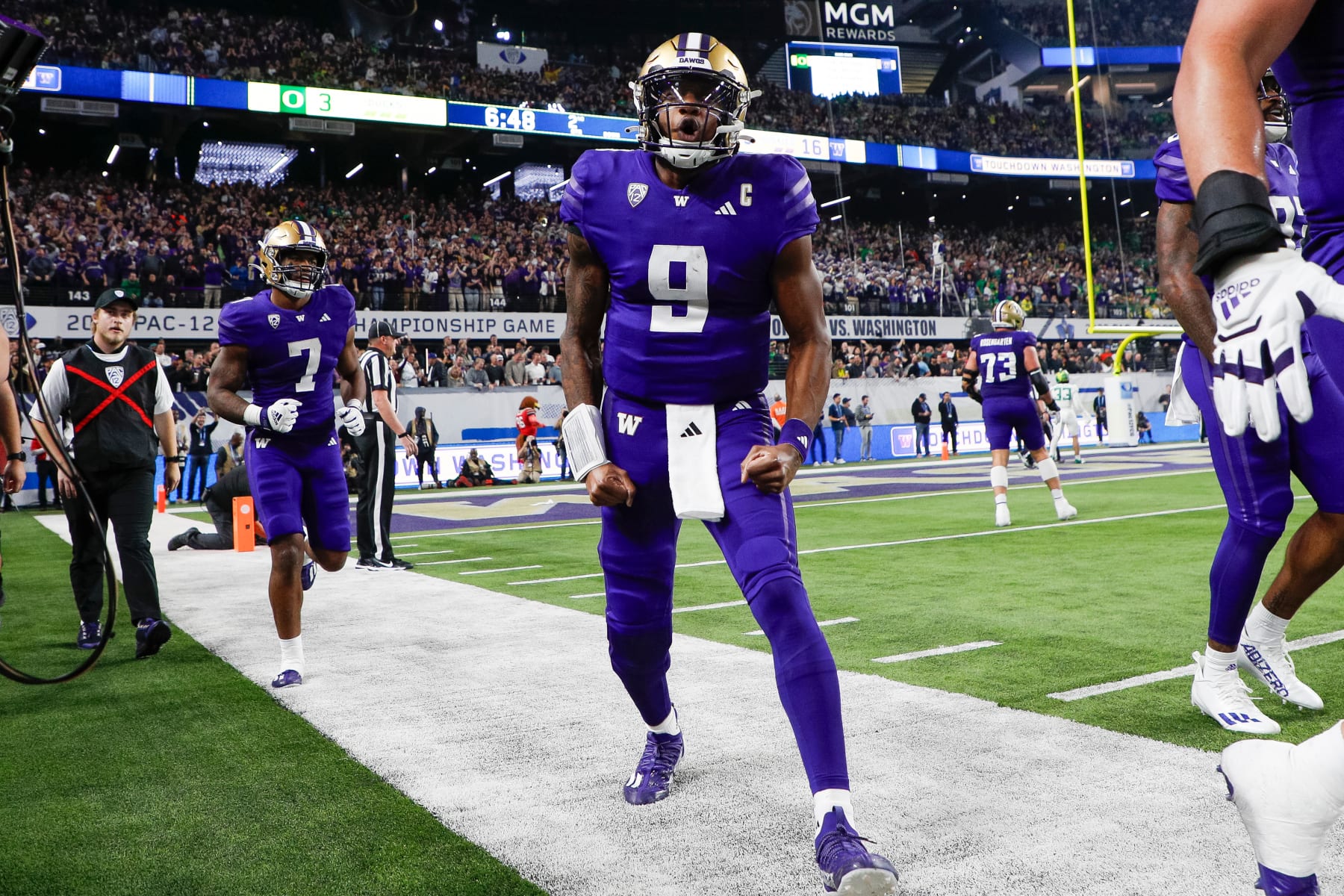 LAS VEGAS, NEVADA - DECEMBER 1: Michael Penix Jr. #9 of the Washington Huskies celebrates after a touchdown by Germie Bernard #4 in the second quarter during the Pac-12 Championship game against the Oregon Ducks at Allegiant Stadium on December 1, 2023 in Las Vegas, Nevada. (Photo by Brandon Sloter/Image Of Sport/Getty Images)