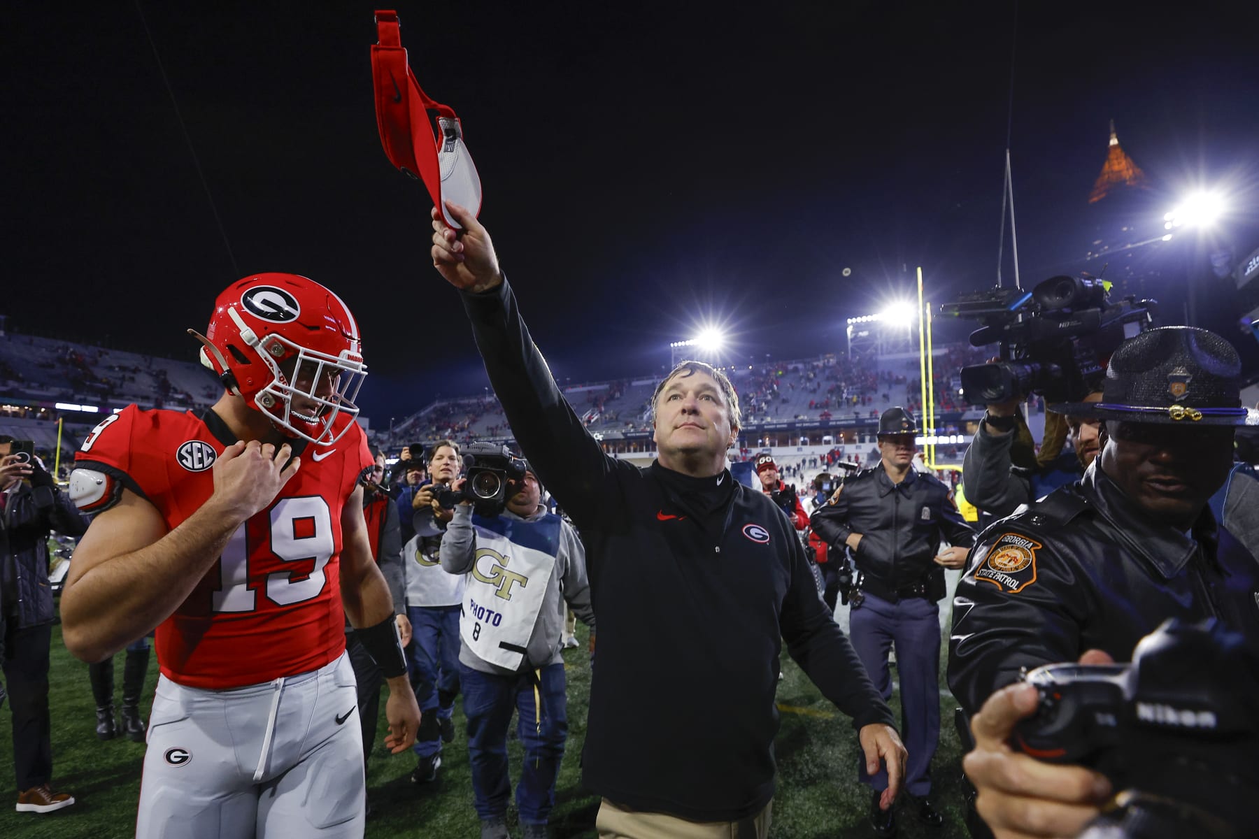 ATLANTA, GEORGIA - NOVEMBER 25: Head coach Kirby Smart leaves the field with Brock Bowers #19 of the Georgia Bulldogs following the 31-23 victory over the Georgia Tech Yellow Jackets at Bobby Dodd Stadium on November 25, 2023 in Atlanta, Georgia. (Photo by Todd Kirkland/Getty Images)